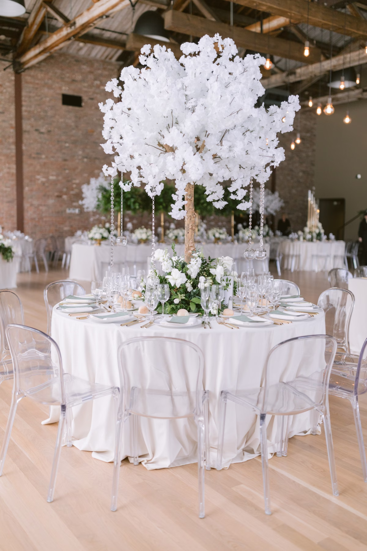 Elegant white floral centerpiece by Maky The Diva Flowers with crystal accents at The Roundhouse Beacon wedding reception