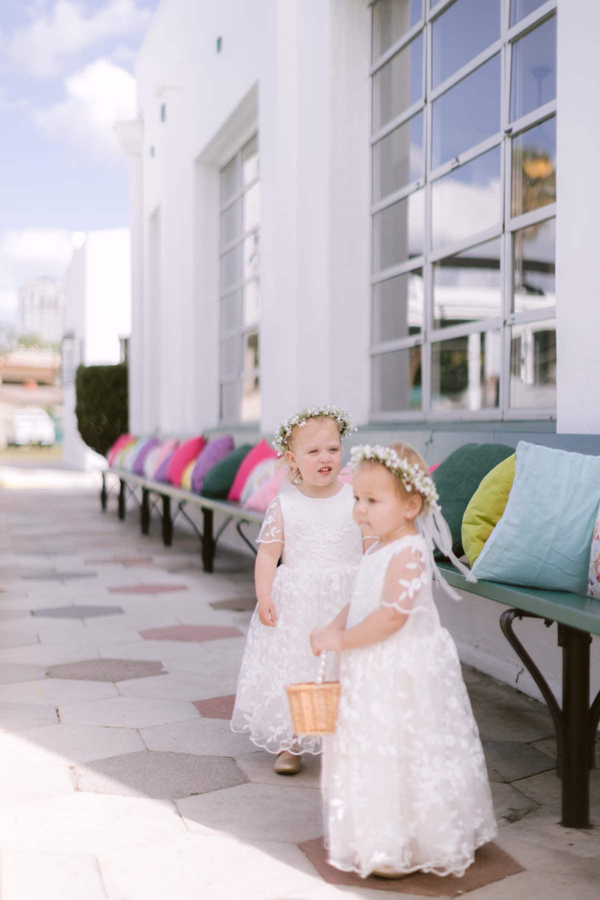 Two adorable flower girls in white lace dresses with floral crowns by Petite Fleur at St Pete Shuffleboard Club wedding
