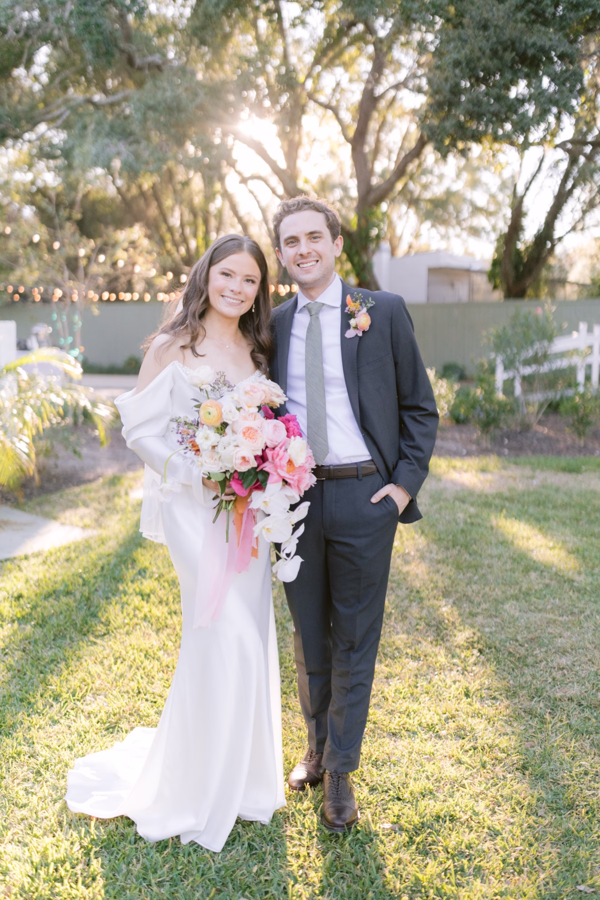 Bride and groom portrait with colorful bouquet by Golden Wild Florals at Soire Estate garden wedding in Tampa