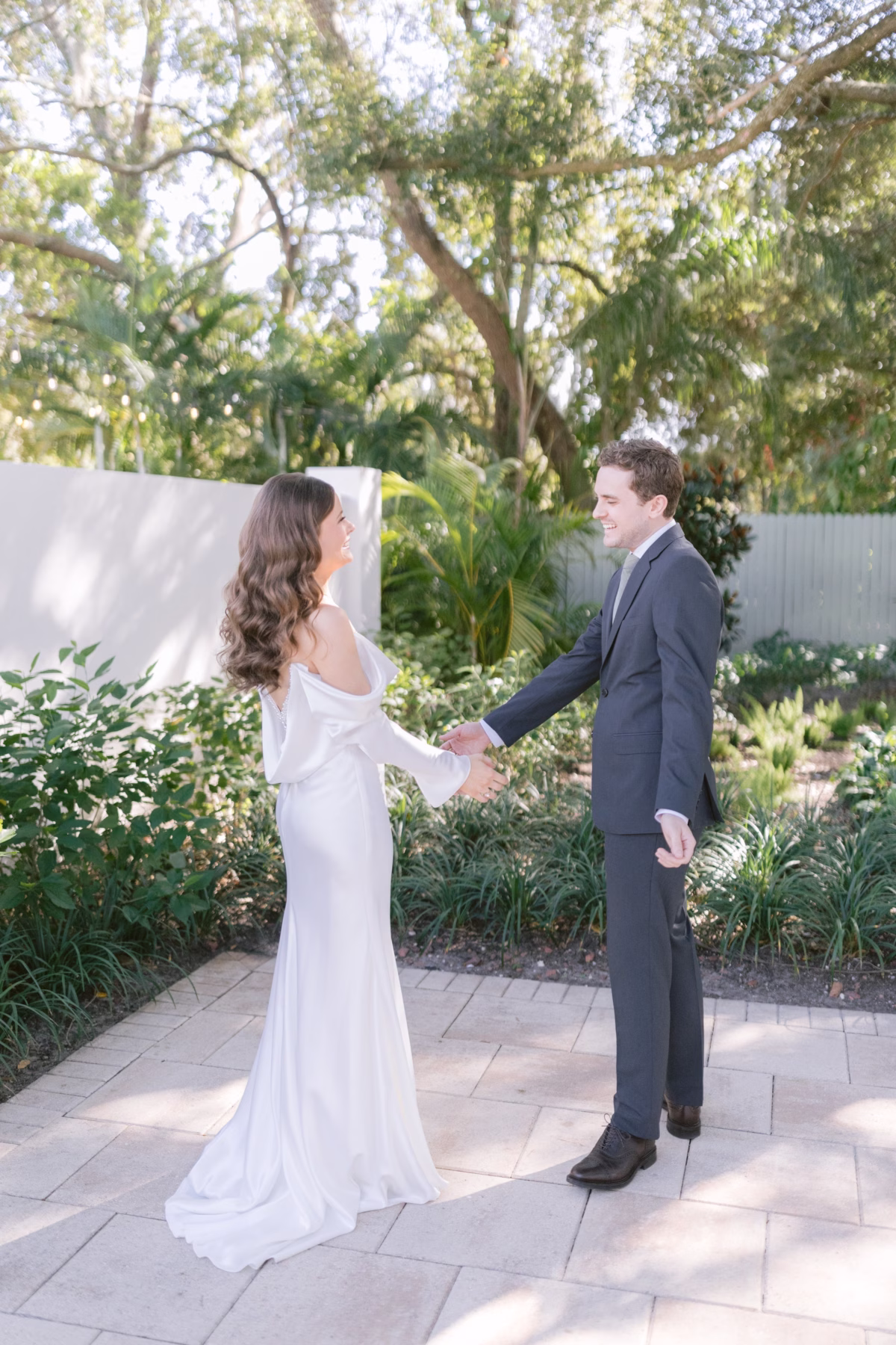 Bride and groom share an intimate first look moment in the lush gardens at Soire Estate Tampa wedding venue captured by Ashley Izquierdo Photography