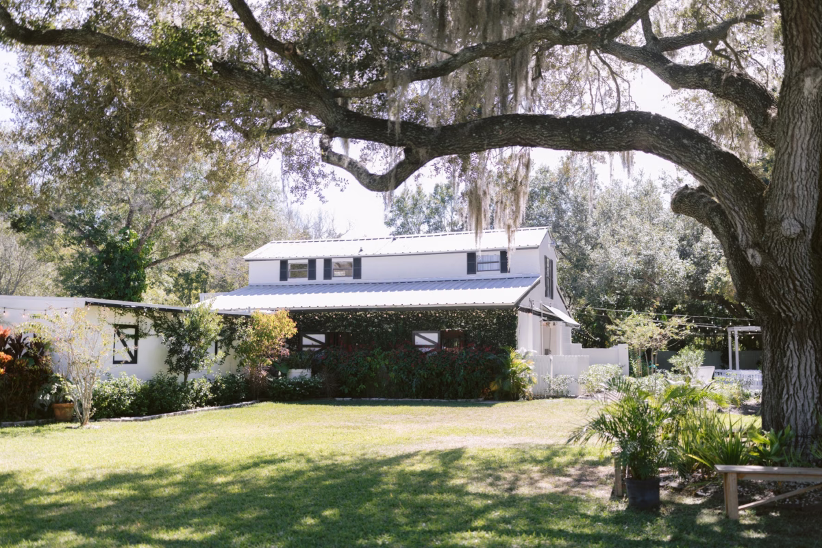 Elegant garden wedding ceremony space at Soire Estate in Tampa with mature oak trees and manicured lawn