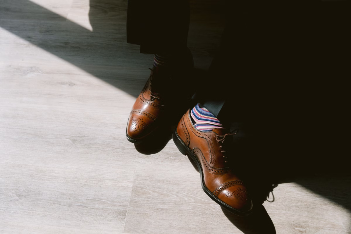 Groom's brown oxford dress shoes with colorful striped socks at St. Petersburg art museum wedding photographed by Ashley Izquierdo Photography