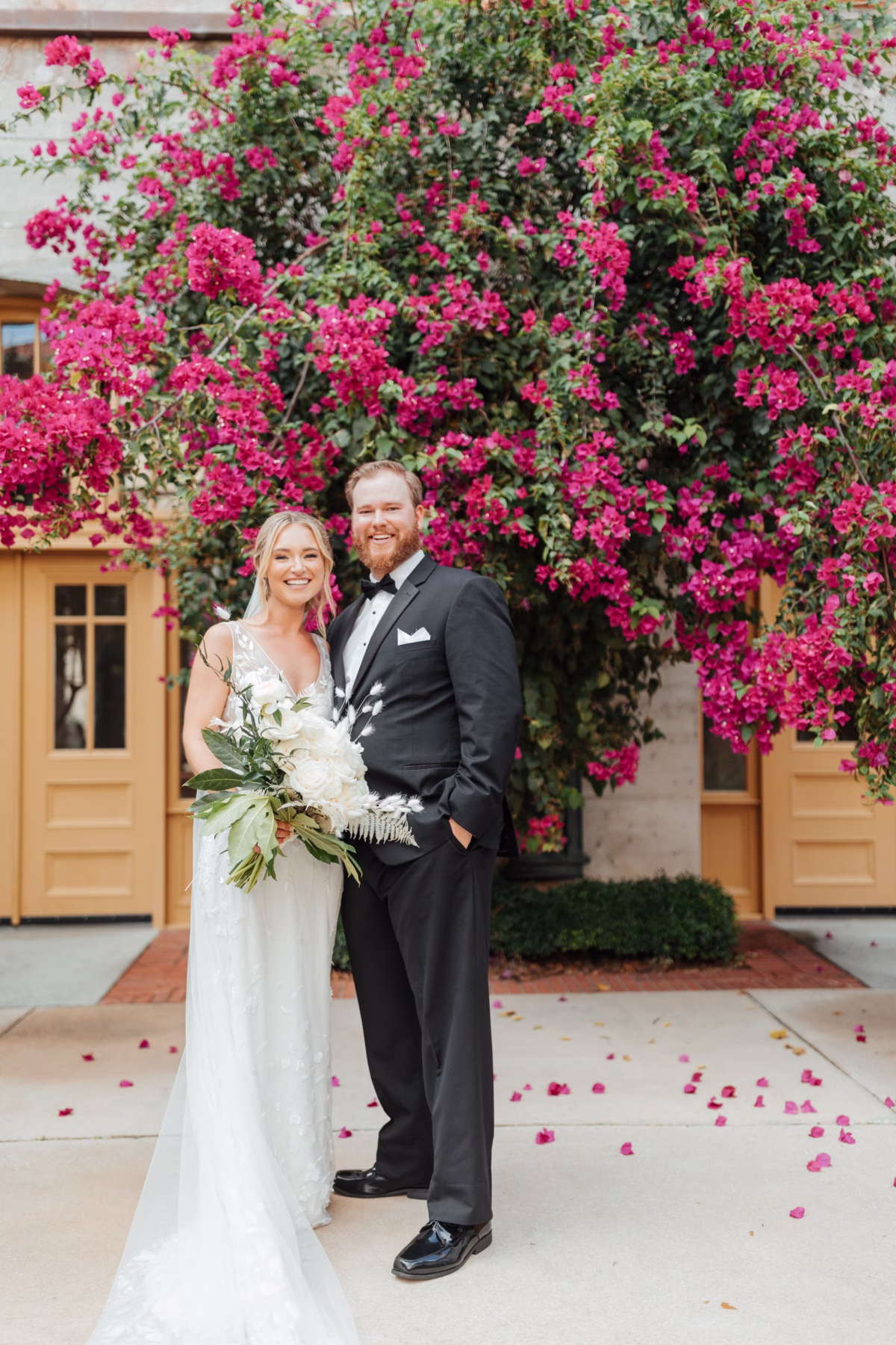 Bride and groom portrait at historic Lightner Museum wedding with vibrant pink bougainvillea backdrop by Aime Peterson Flowers photographed by Ashley Izquierdo Photography