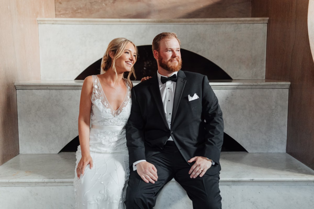Bride and groom sitting together at historic Lightner Museum wedding planned by Coastal Celebrations in St. Augustine