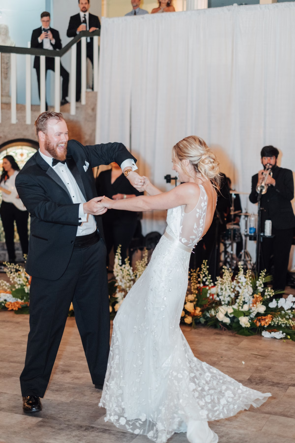 Bride and groom sharing their first dance at historic Lightner Museum wedding coordinated by Coastal Celebrations with floral arrangements by Aime Peterson Flowers