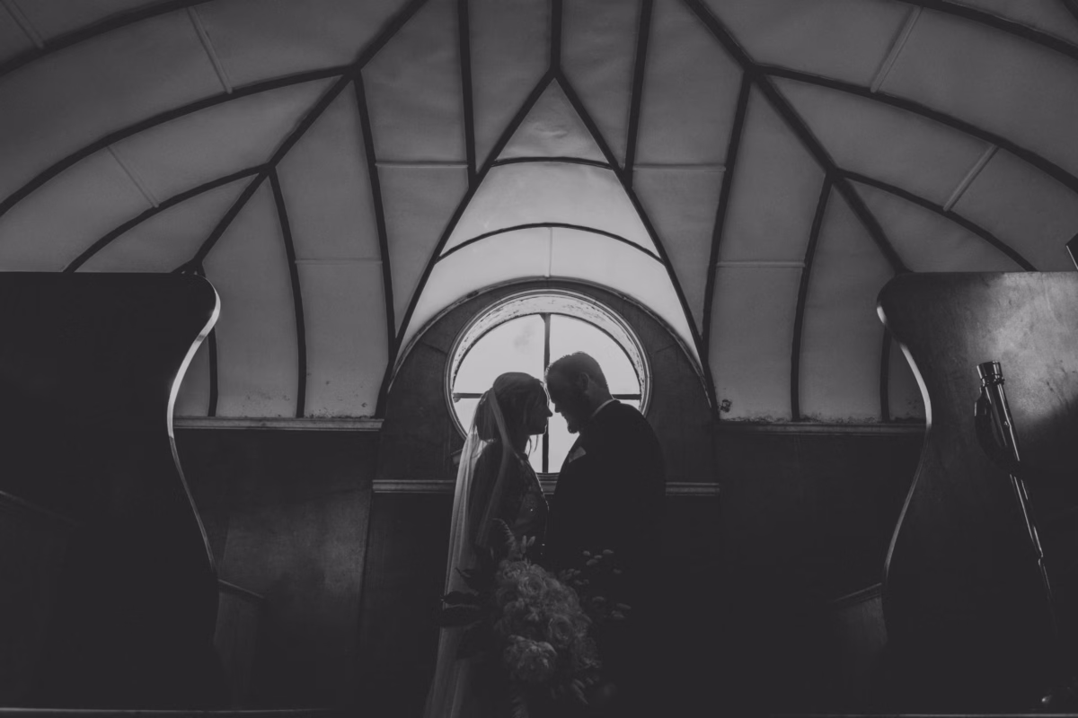 Bride and groom romantic portrait in historic arched hallway at The Lightner Museum wedding planned by Coastal Celebrations in St Augustine