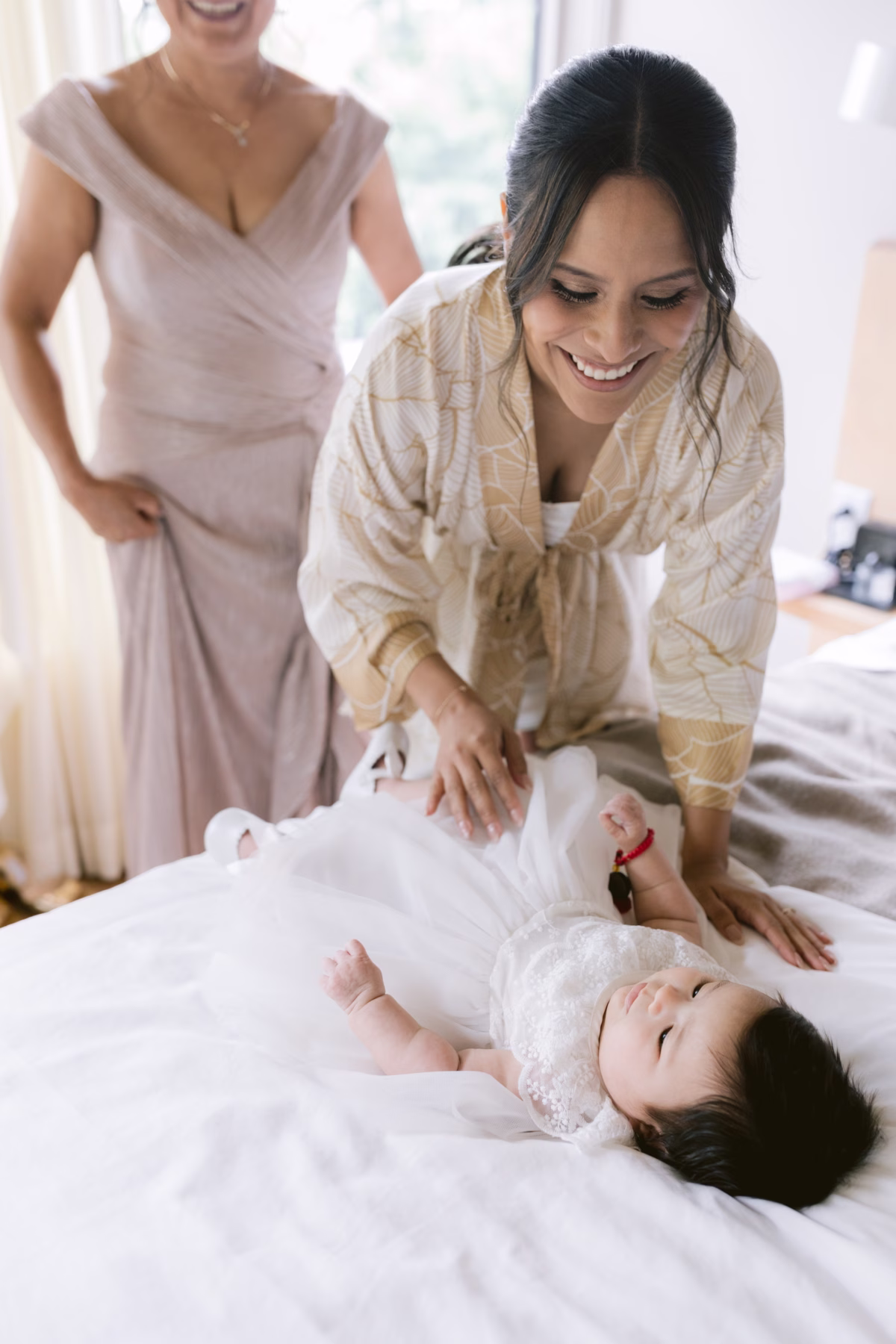 Bride in robe playing with flower girl during getting ready at The Roundhouse Beacon Hudson Valley wedding photographed by Ashley Izquierdo Photography