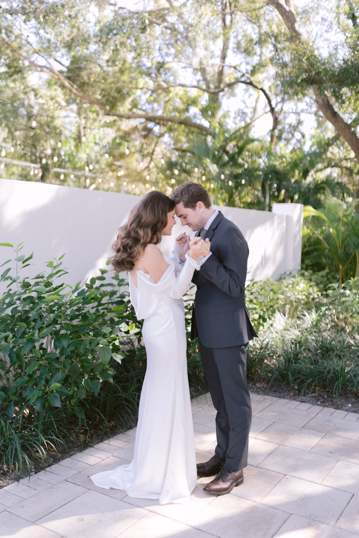 Bride and groom share an intimate moment in the lush gardens at Soire Estate Tampa wedding venue photographed by Ashley Izquierdo Photography