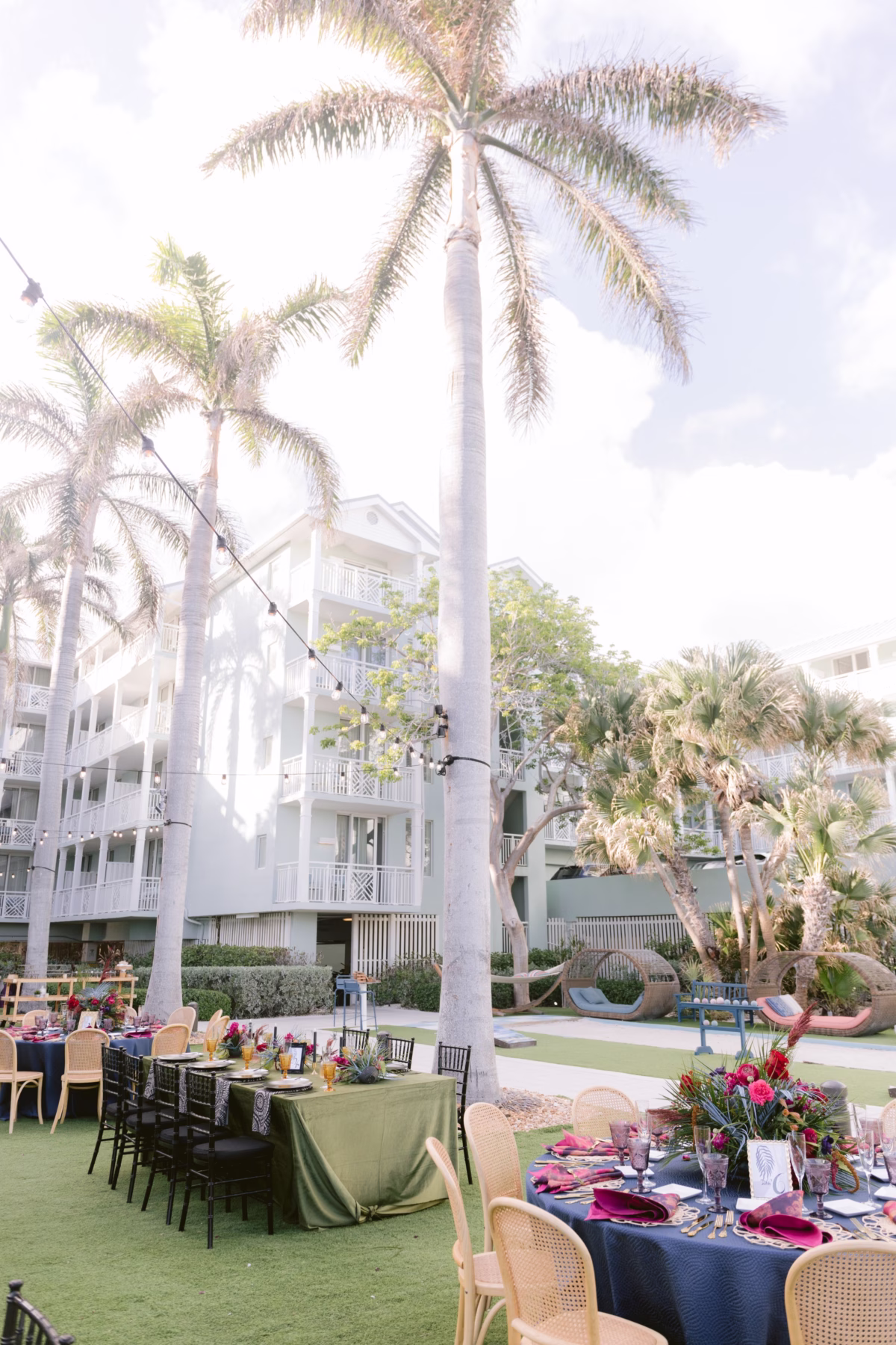 Elegant outdoor wedding reception with jewel tone linens and tropical florals by Arms of Persephone at Casa Marina Key West photographed by Ashley Izquierdo Photography