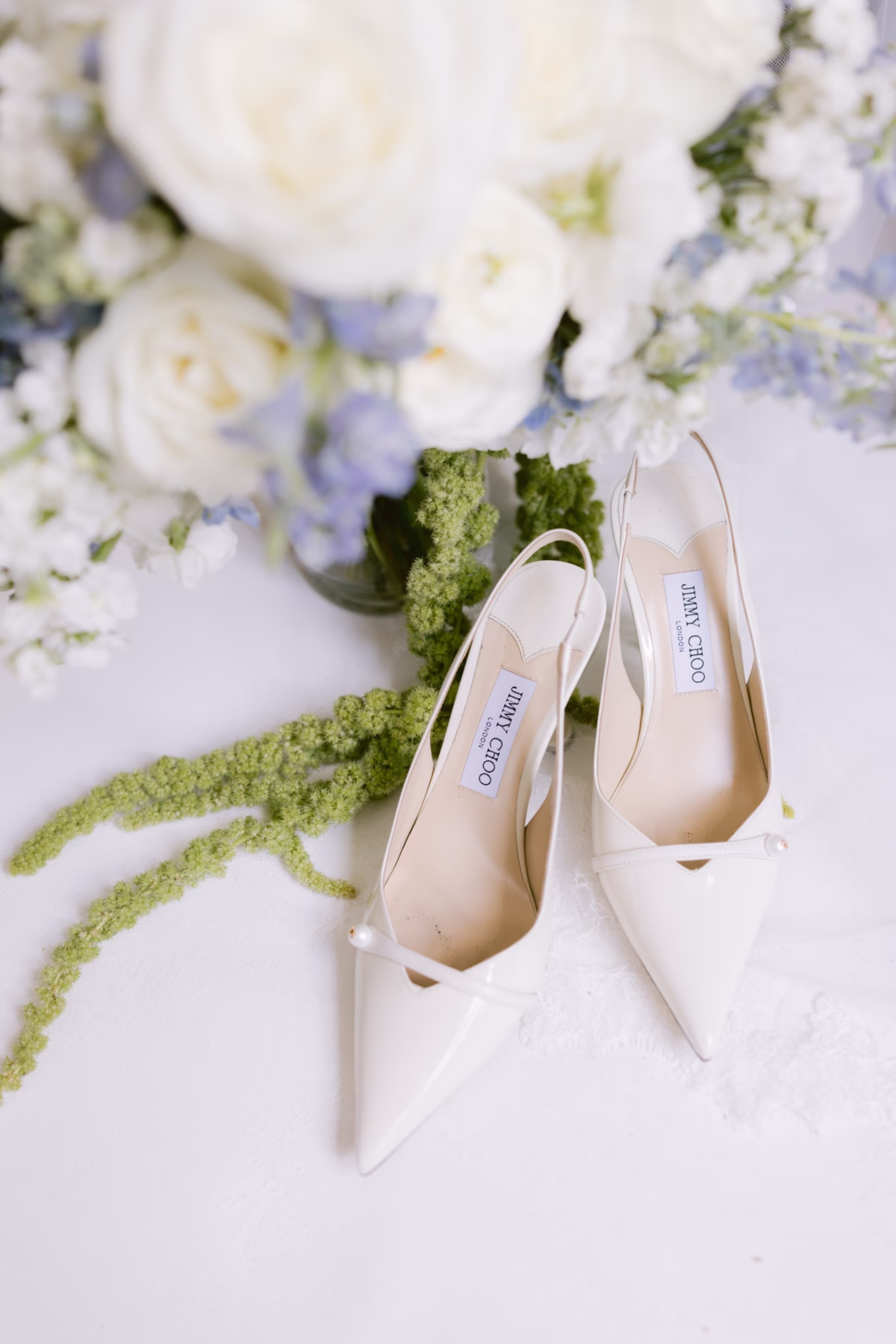Jimmy Choo wedding shoes with white and blue bridal bouquet by Ava Elise Decor at Soire Estate Tampa wedding