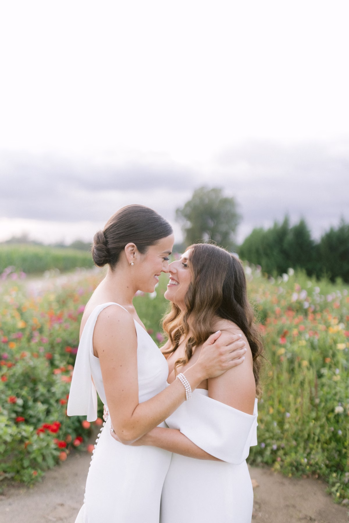 johnsons locust hall farm wedding couple portrait new jersey - A Farm Wedding at Johnson's Locust Hall, New Jersey Two brides in white dresses share an intimate moment in a colorful flower field at Johnson's Locust Hall farm wedding venue in New Jersey