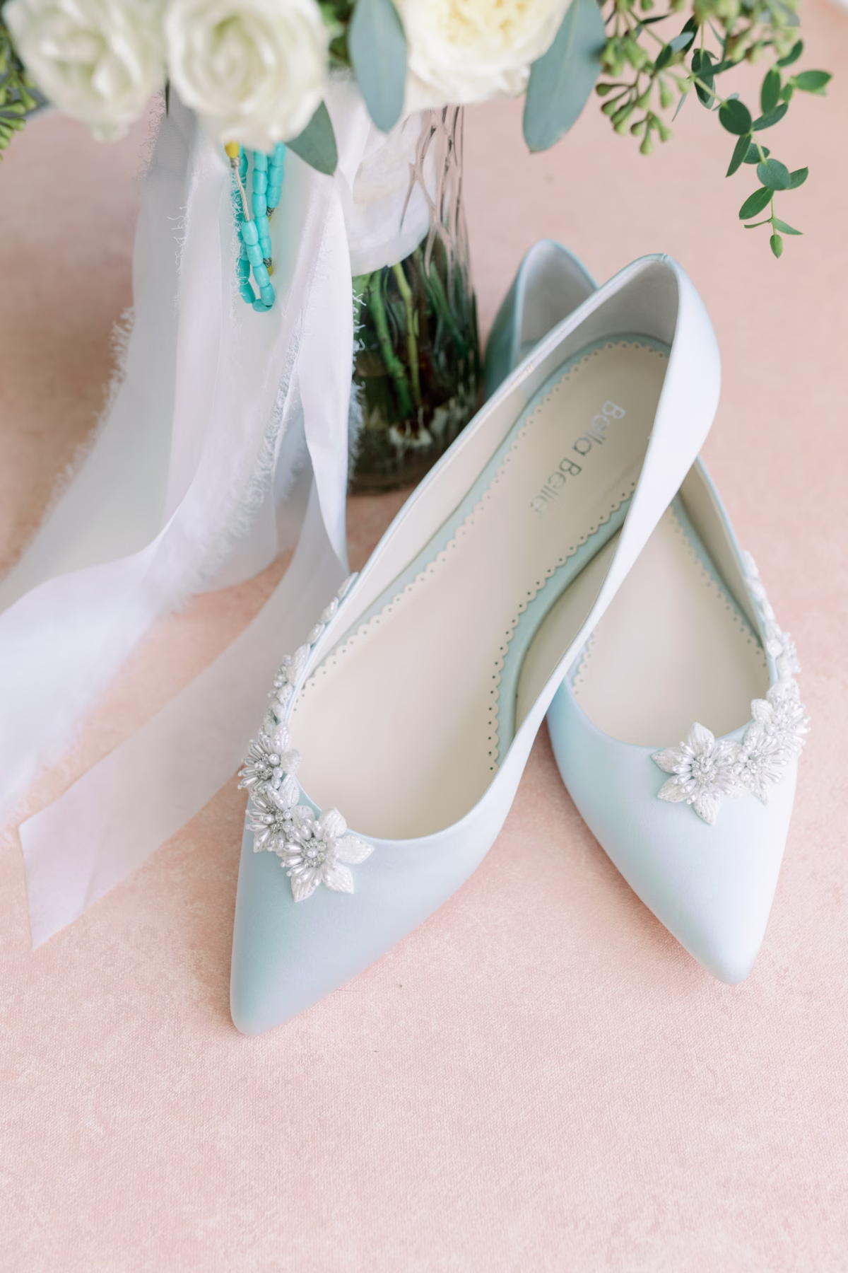 Light blue bridal shoes with crystal details styled with white florals and veil for Vinoy St. Petersburg waterfront wedding