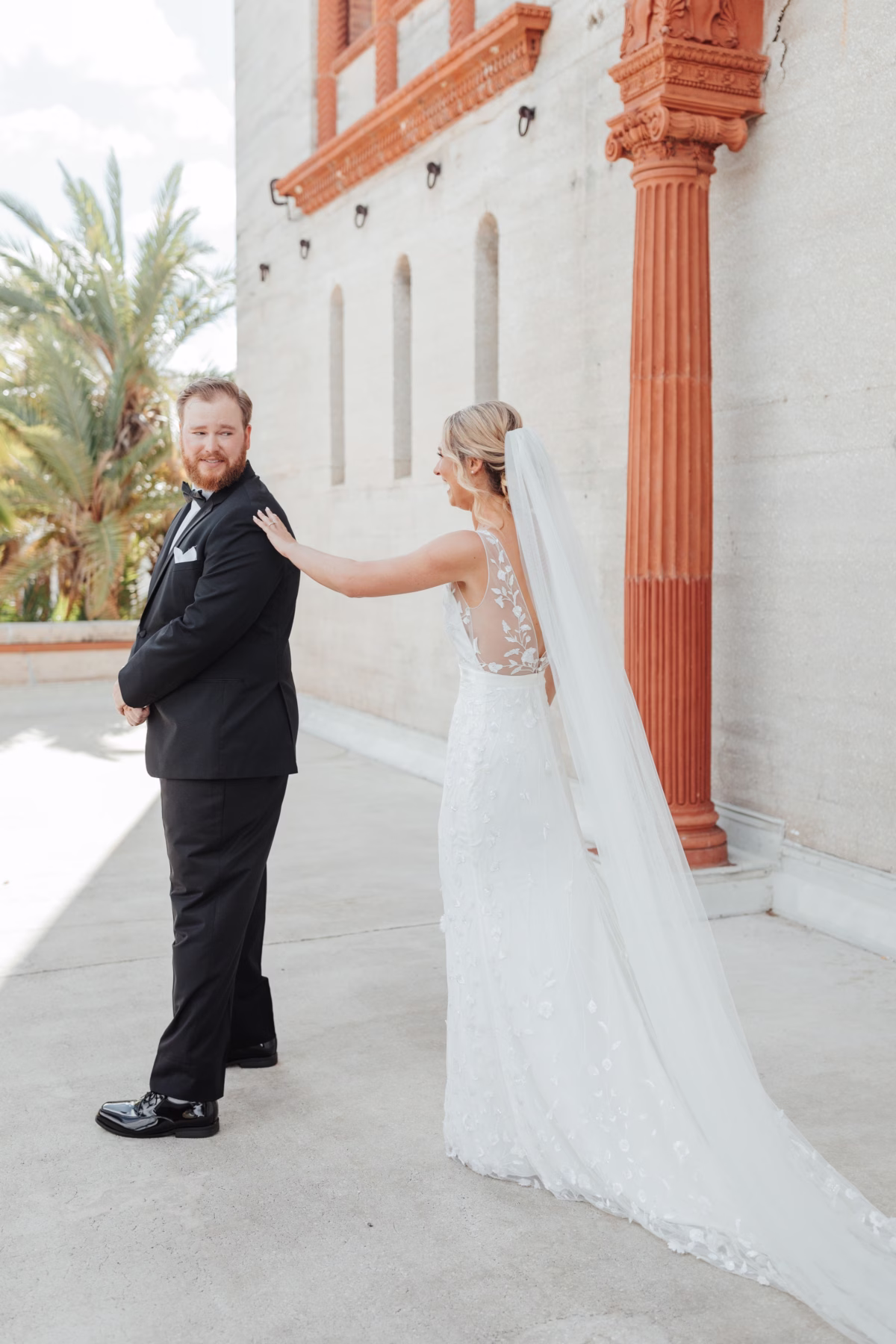 Bride and groom share emotional first look moment at historic Lightner Museum wedding planned by Coastal Celebrations in St Augustine