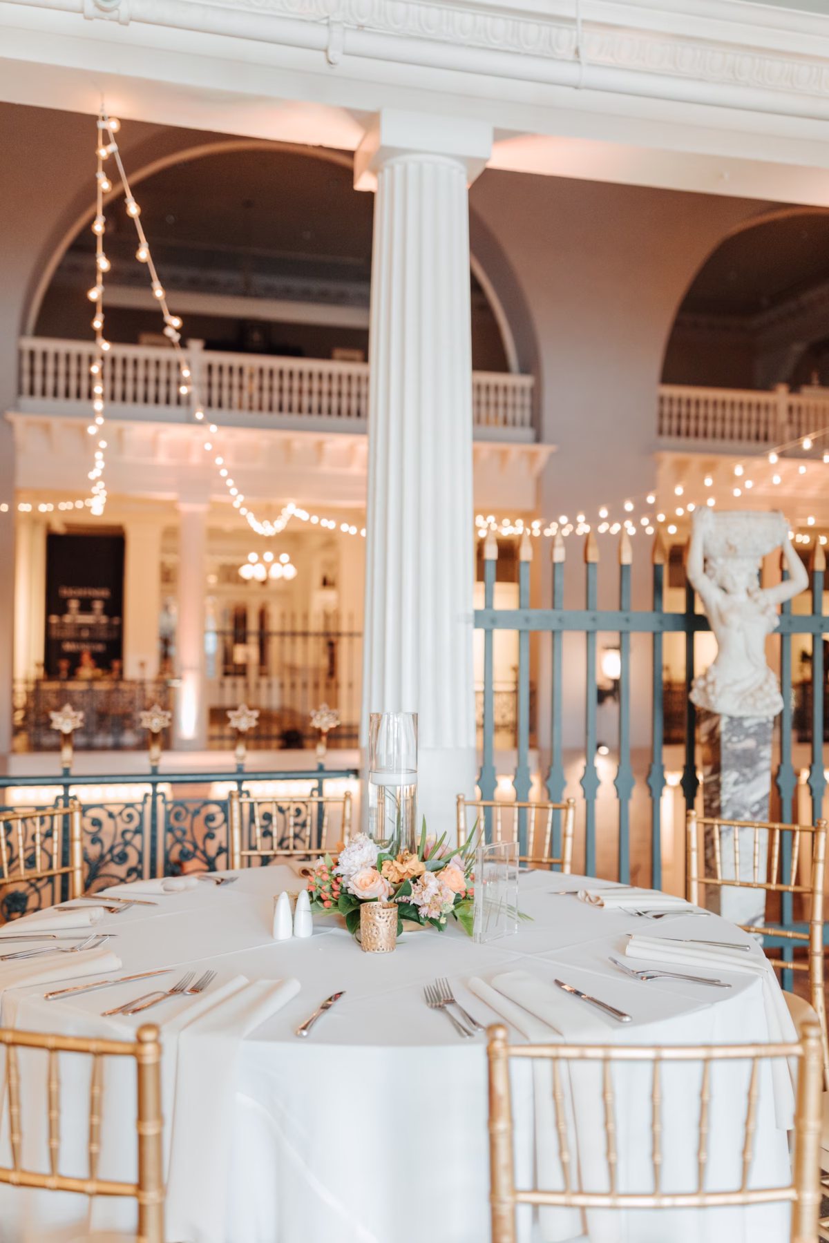 Elegant wedding reception table with blush floral centerpiece by Aime Peterson Flowers at The Lightner Museum historic venue in St Augustine