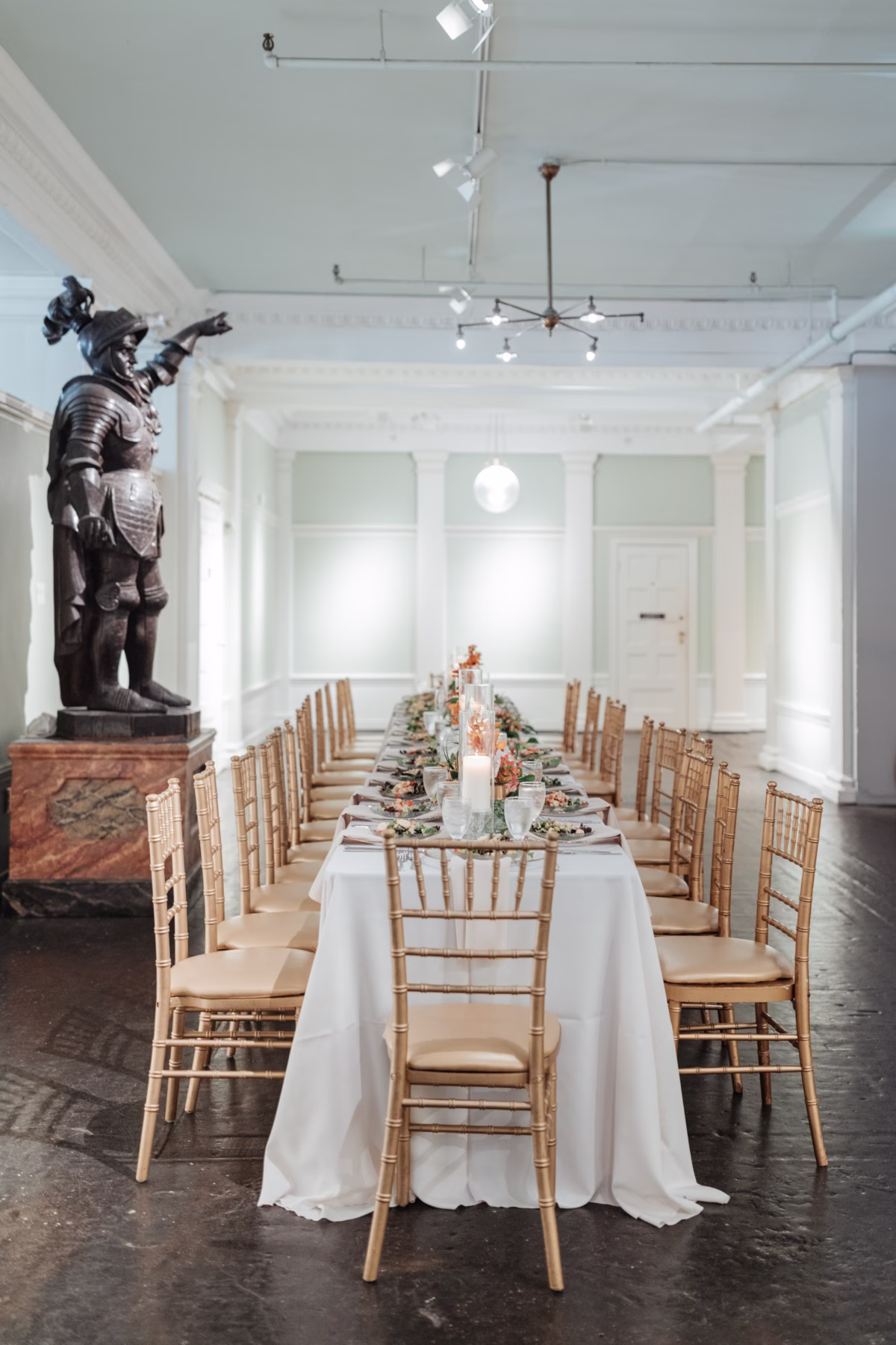 Elegant wedding reception table with gold chiavari chairs and floral centerpieces by Aime Peterson Flowers at The Lightner Museum in St Augustine