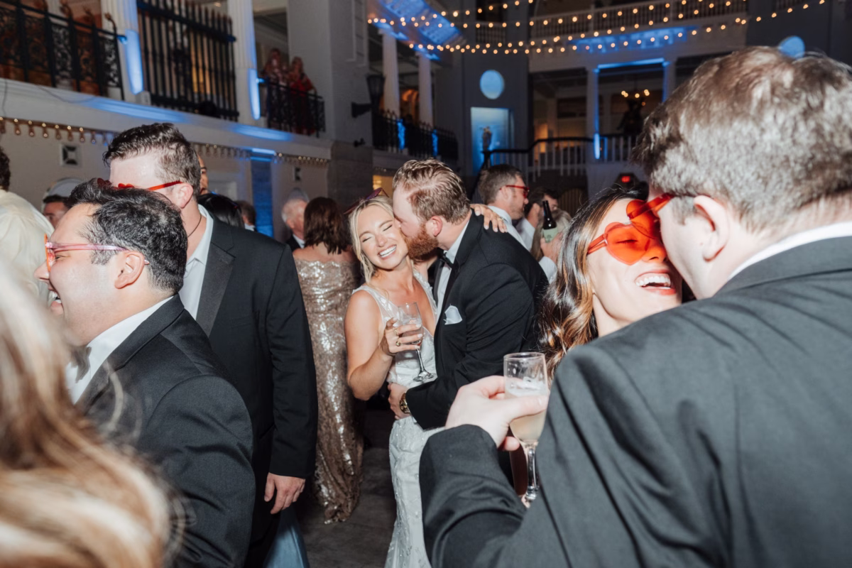 Elegant wedding reception celebration at The Lightner Museum in St. Augustine with guests enjoying cocktails and dancing, coordinated by Coastal Celebrations wedding planning