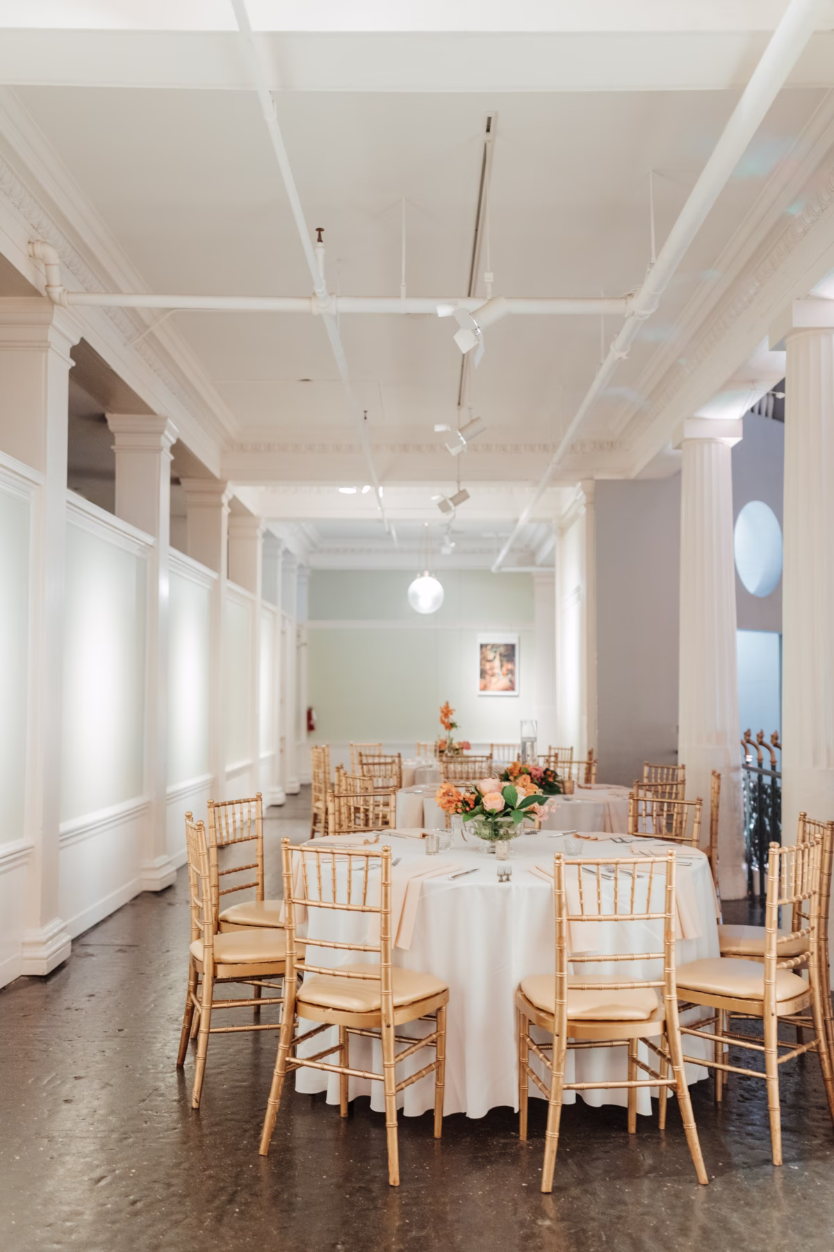 Elegant wedding reception with gold chiavari chairs and floral centerpieces at The Lightner Museum planned by Coastal Celebrations with flowers by Aime Peterson Flowers