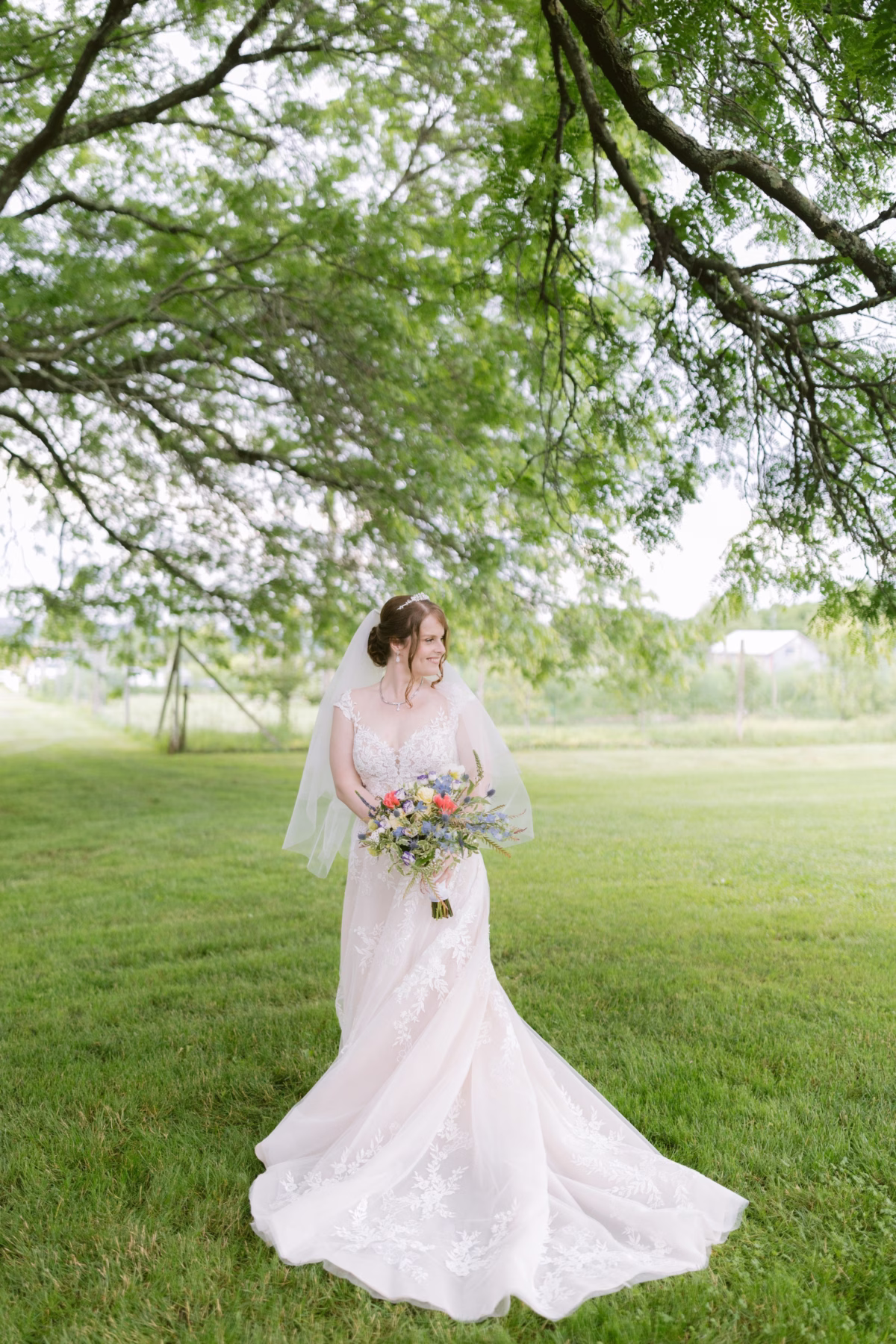 Bride in Maggie Sottero wedding dress with Cherry Brandy Designs wildflower bouquet at Red Maple Vineyard in Tampa Bay