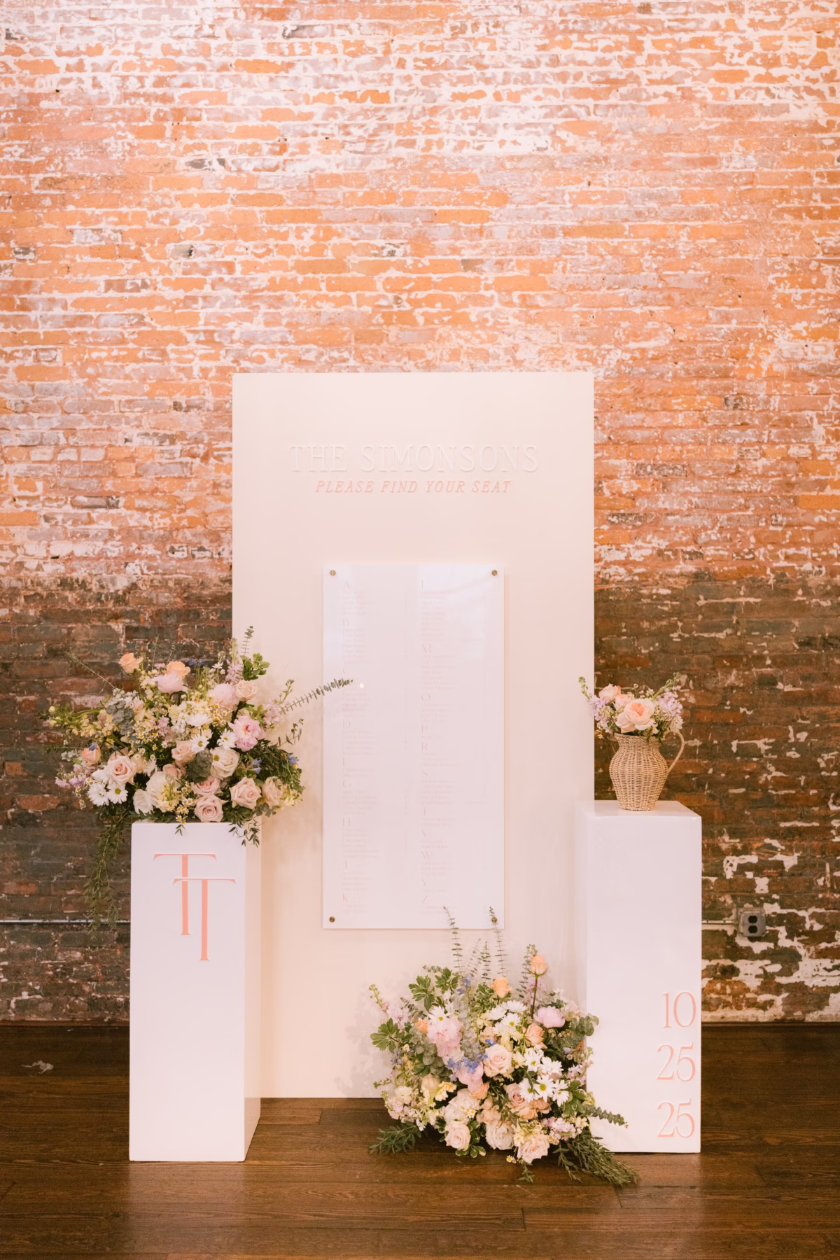 Modern white geometric ceremony backdrop with pink roses and eucalyptus florals by I Dew Events at Armature Works Tampa wedding