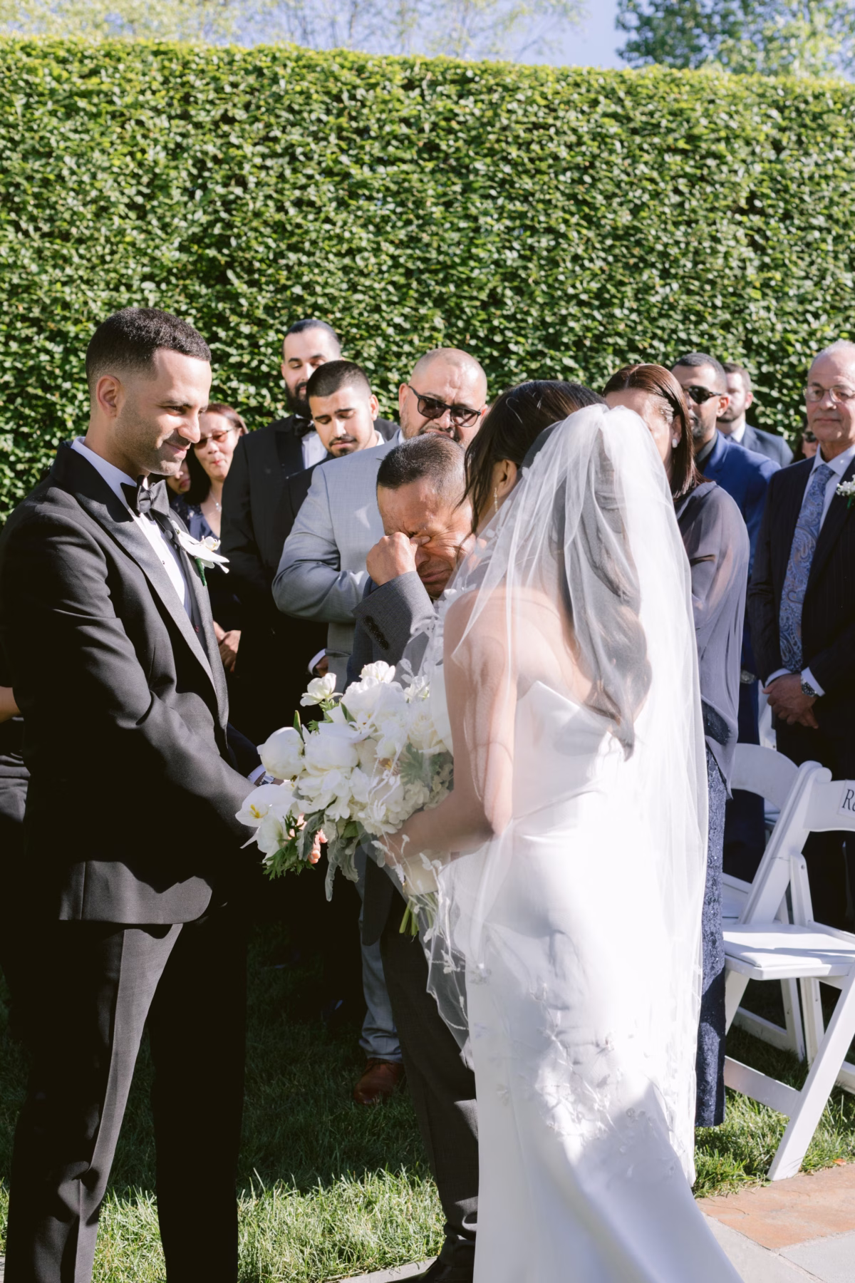 Bride holding white wedding bouquet by Maky The Diva Flowers during outdoor ceremony at The Roundhouse Beacon in Hudson Valley