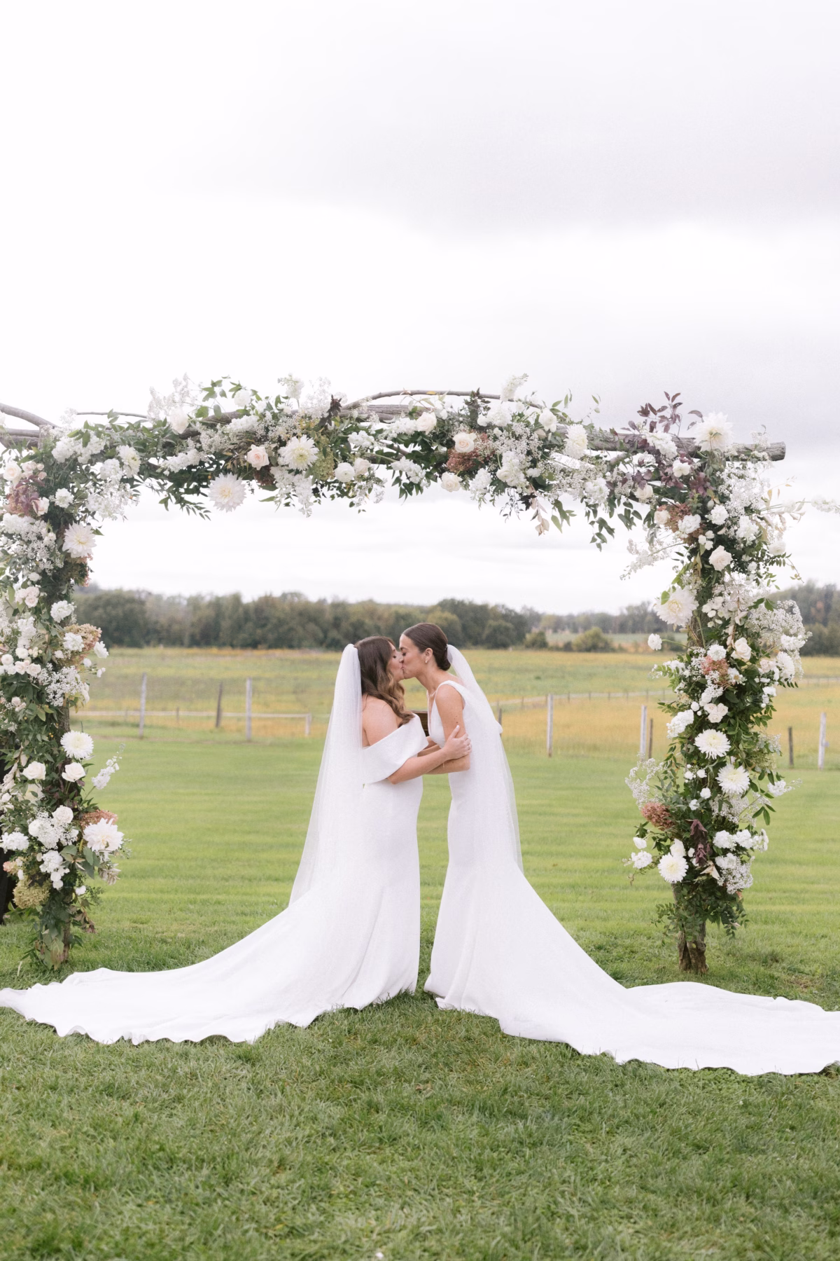 outdoor farm wedding ceremony floral arch johnsons locust hall allie johnson florist - A Farm Wedding at Johnson's Locust Hall, New Jersey Two brides kiss under a lush floral ceremony arch at Johnson's Locust Hall farm wedding in New Jersey with flowers by Allie Johnson