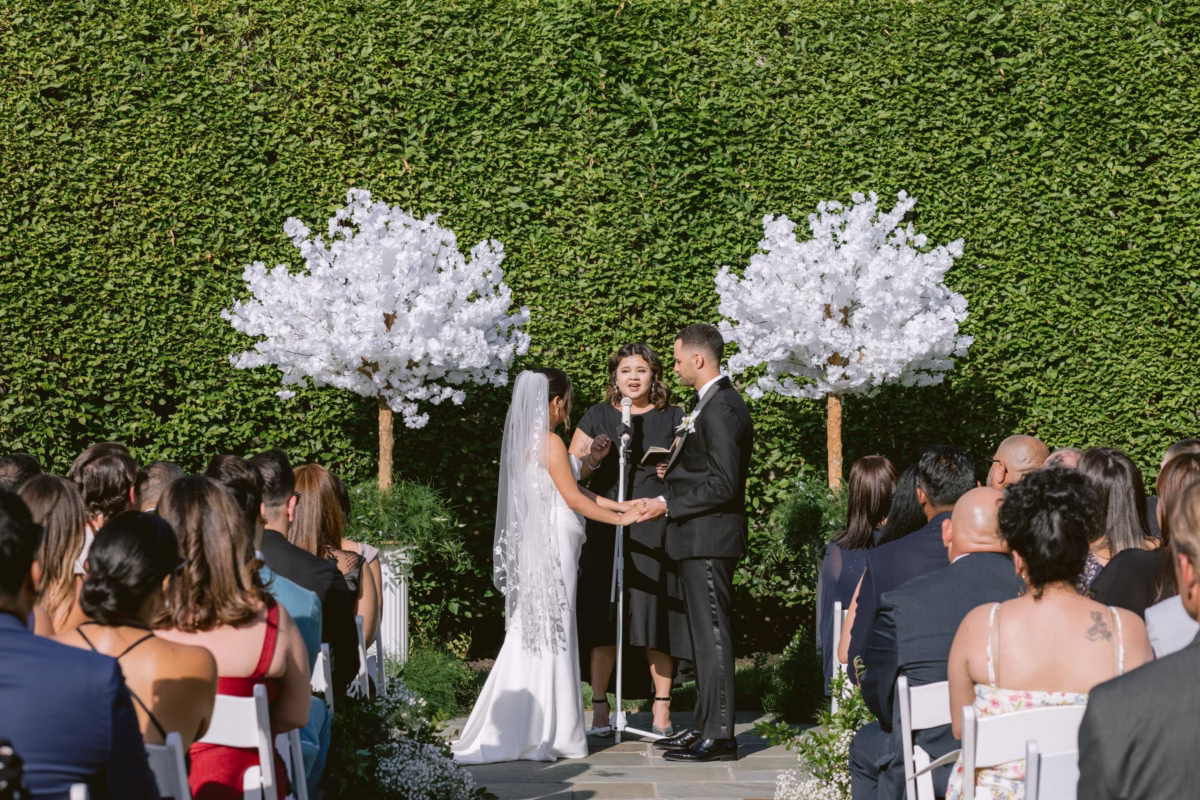 Outdoor wedding ceremony with white floral arrangements by Maky The Diva Flowers at The Roundhouse Beacon venue in Hudson Valley