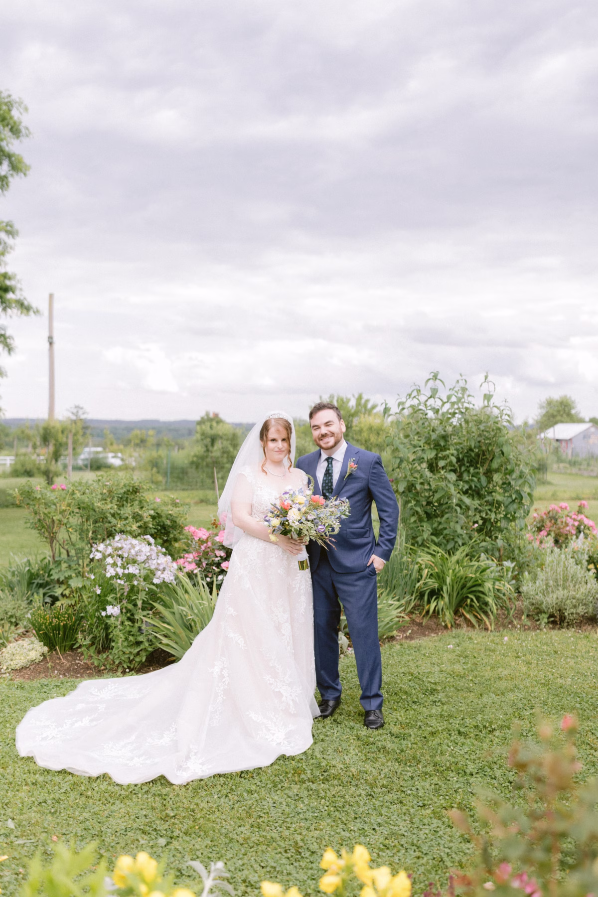 Bride and groom with wildflower bouquet by Cherry Brandy Designs at Red Maple Vineyard wedding photographed by Ashley Izquierdo Photography