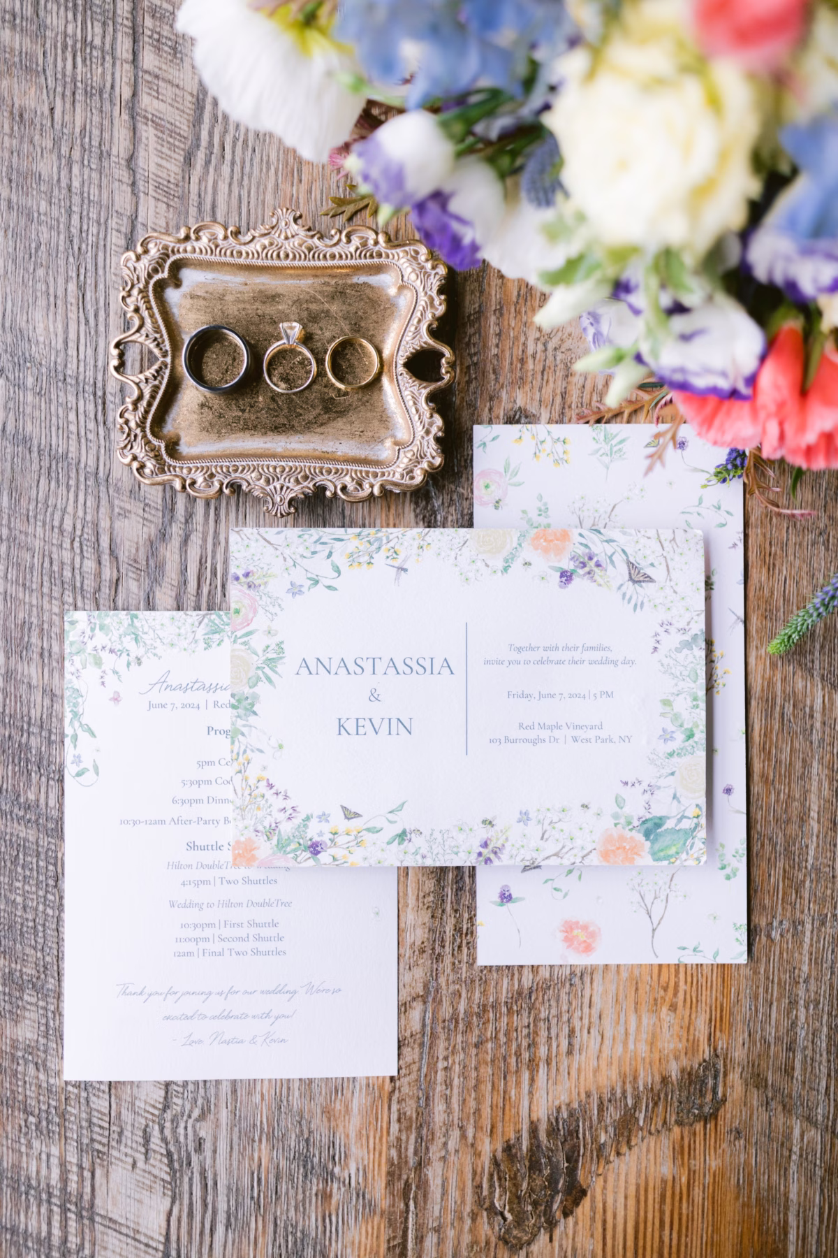 Elegant floral wedding invitation suite by Zola with rings displayed on ornate vintage tray at Red Maple Vineyard wedding