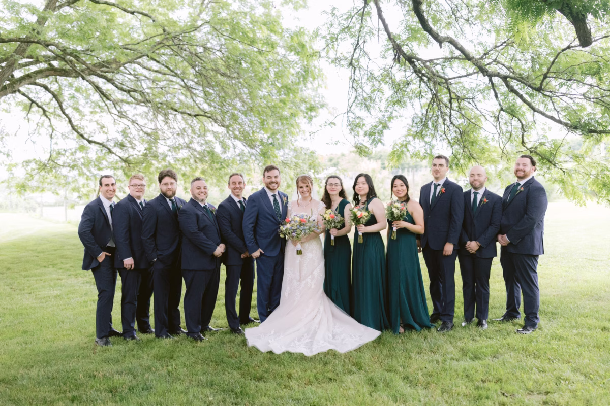 Wedding party portraits under trees at Red Maple Vineyard with bride in Maggie Sottero gown and bridesmaids holding Cherry Brandy Designs bouquets