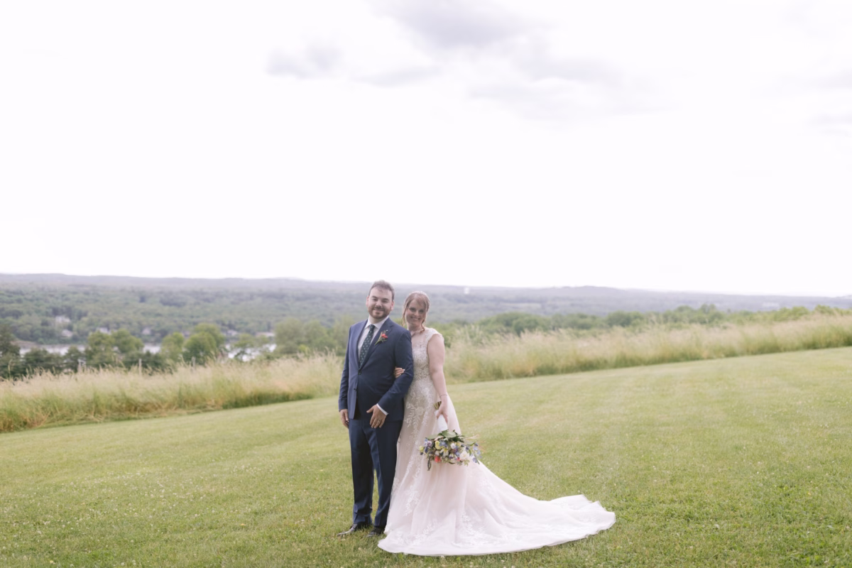 Bride and groom wedding portrait at Red Maple Vineyard with Cherry Brandy Designs wildflower bouquet overlooking Tampa Bay countryside