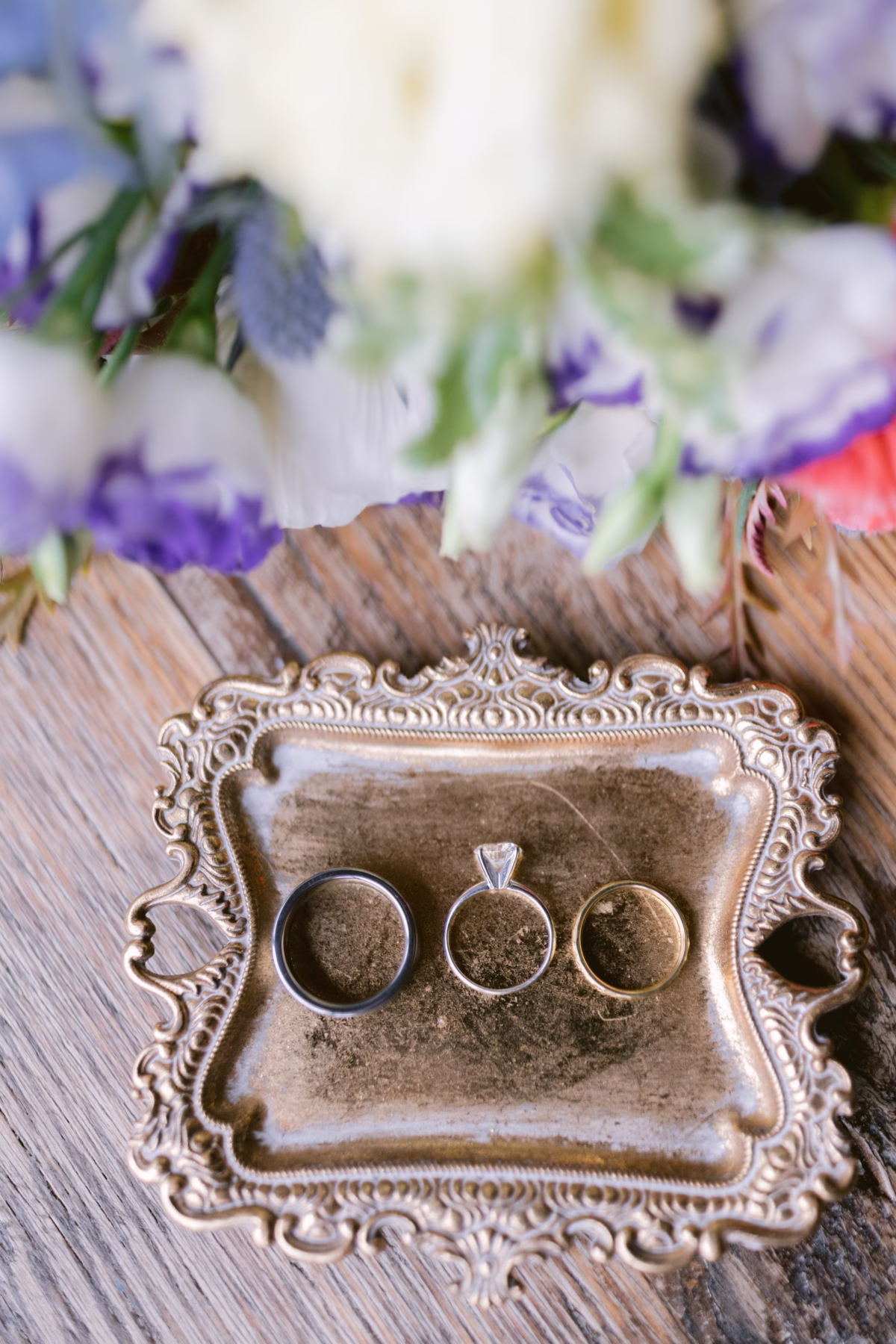 Wedding rings displayed on ornate vintage silver tray at Red Maple Vineyard wedding photographed by Ashley Izquierdo Photography