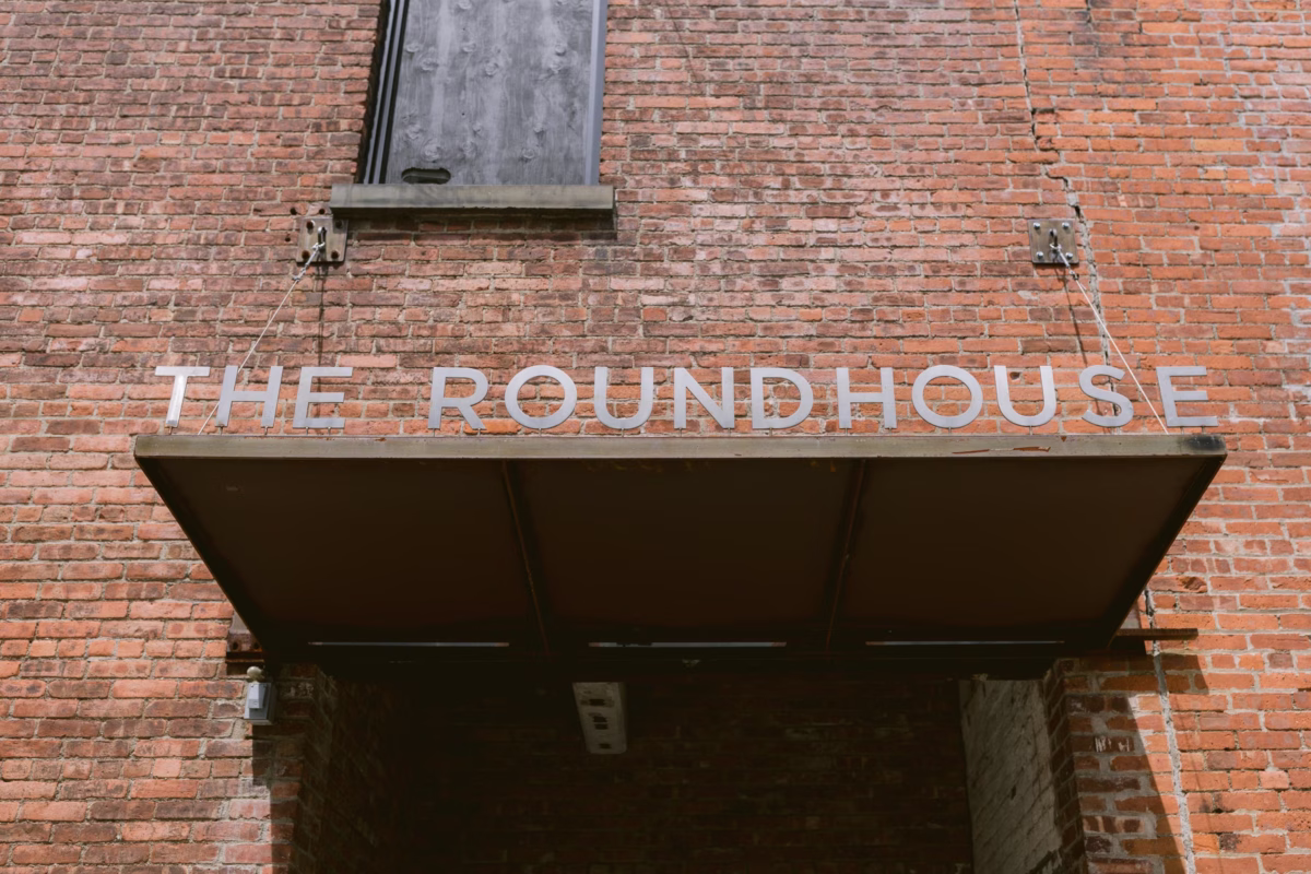 The Roundhouse Beacon venue exterior showing historic brick building with signage for Hudson Valley wedding photographed by Ashley Izquierdo Photography