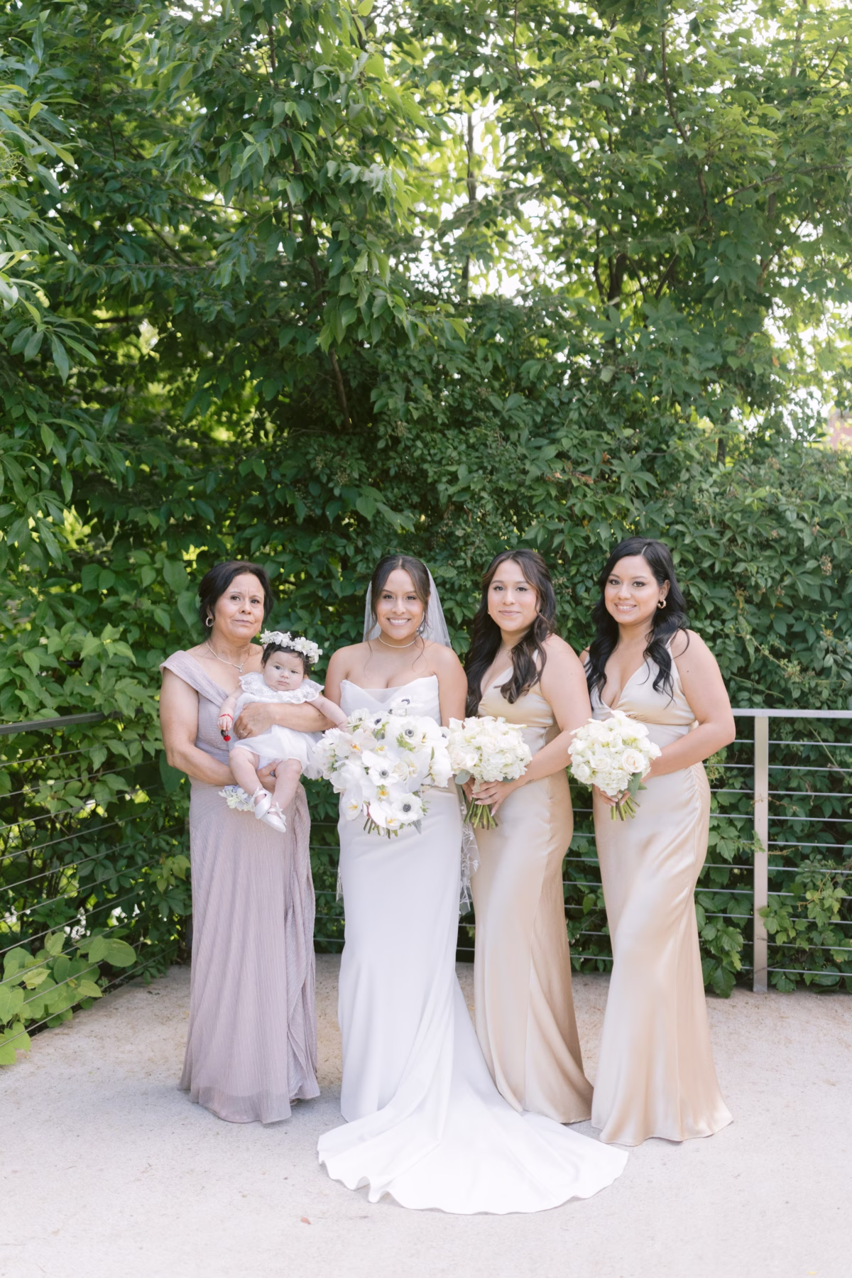Bride with bridesmaids holding white floral bouquets by Maky The Diva Flowers at The Roundhouse Beacon Hudson Valley wedding