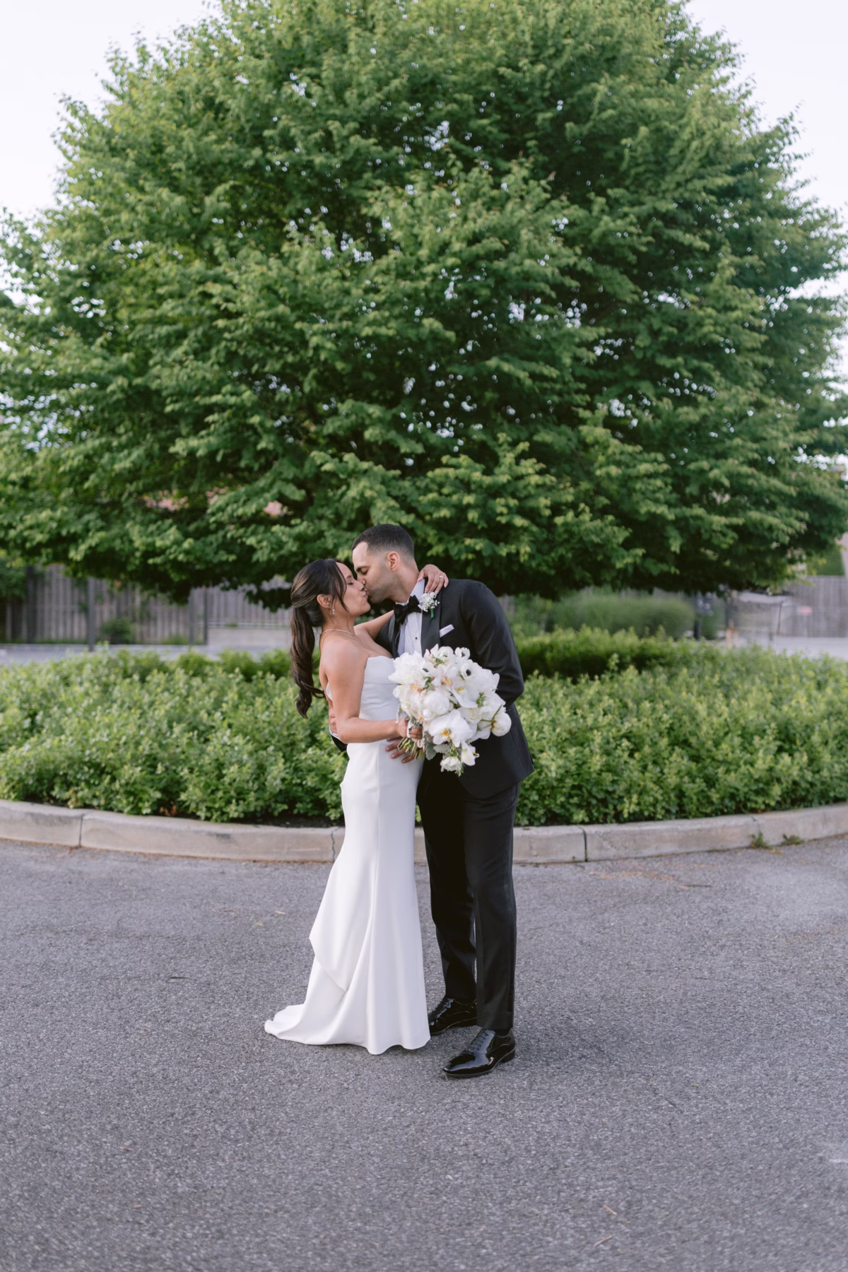 Bride and groom sharing intimate moment with white floral bouquet by Maky The Diva Flowers at The Roundhouse Beacon Hudson Valley wedding