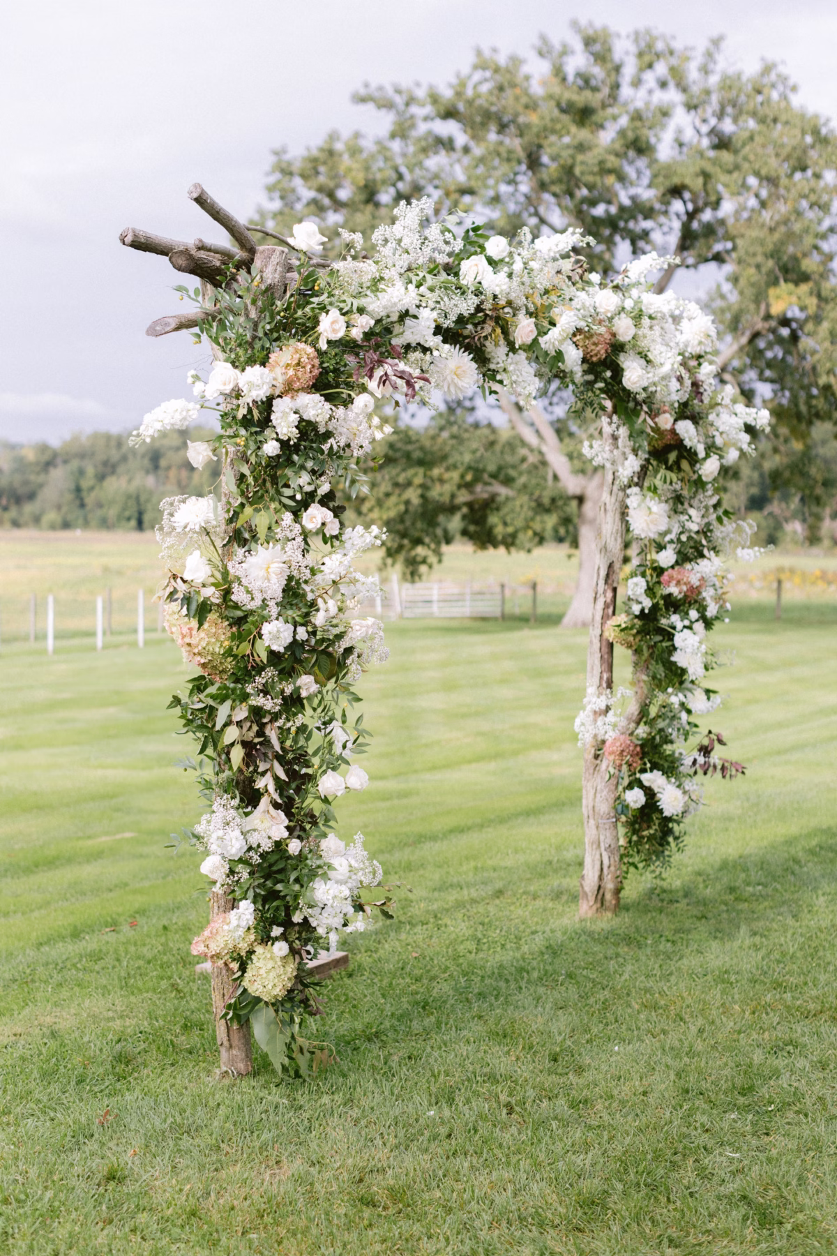 rustic wedding arch florist allie johnson johnsons locust hall farm - A Farm Wedding at Johnson's Locust Hall, New Jersey Rustic wooden wedding arch with white flowers by florist Allie Johnson at Johnson's Locust Hall farm wedding venue in New Jersey