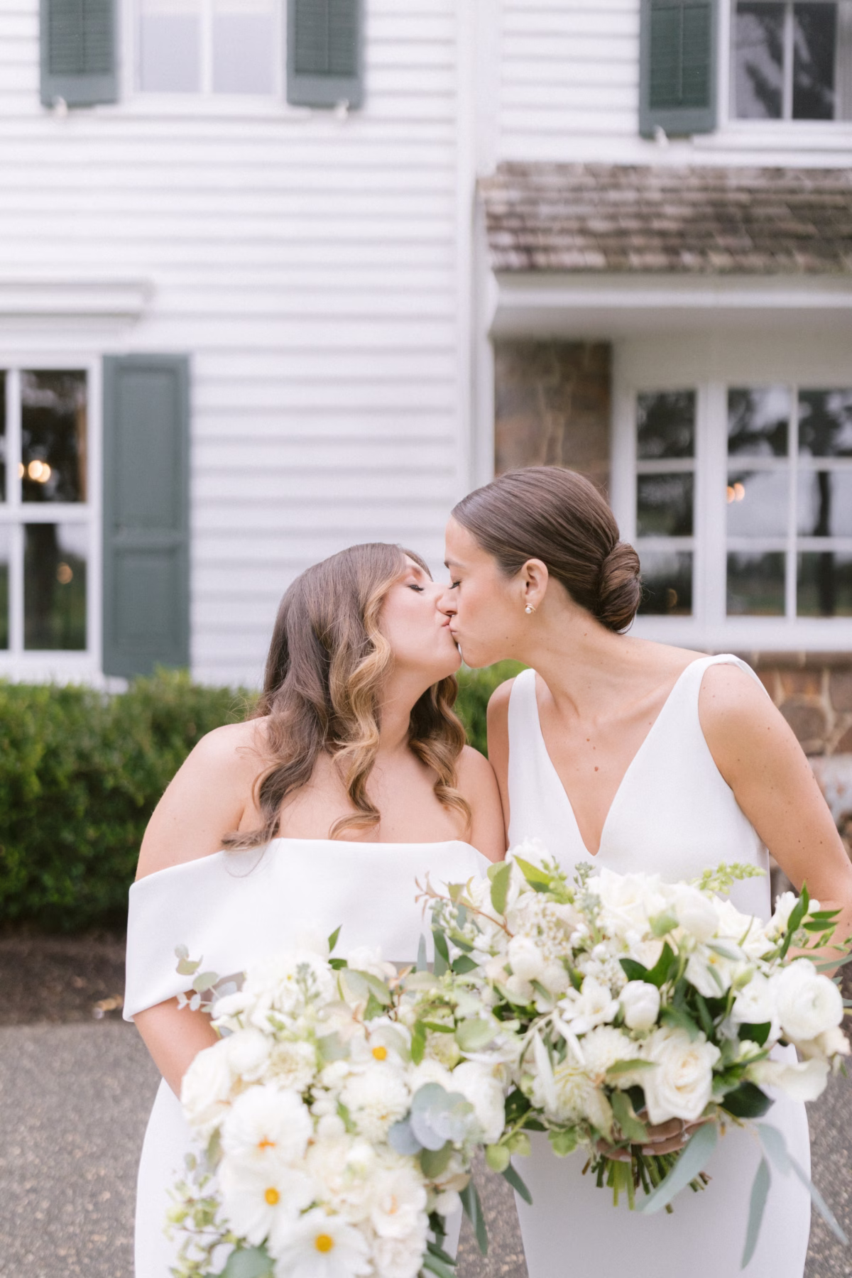 same sex wedding johnsons locust hall florist allie johnson - A Farm Wedding at Johnson's Locust Hall, New Jersey Two brides sharing a kiss while holding white floral bouquets by Allie Johnson at Johnson's Locust Hall farm wedding in New Jersey