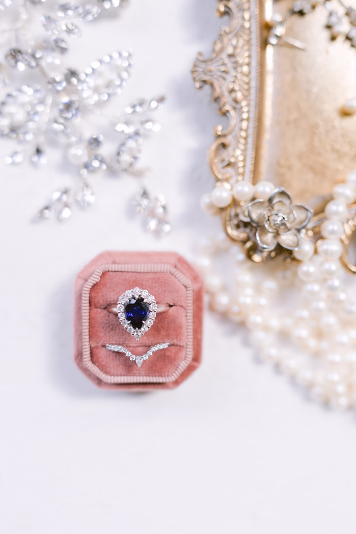 Sapphire engagement ring with diamond halo and matching wedding band in velvet ring box at Armature Works Tampa wedding photographed by Ashley Izquierdo Photography