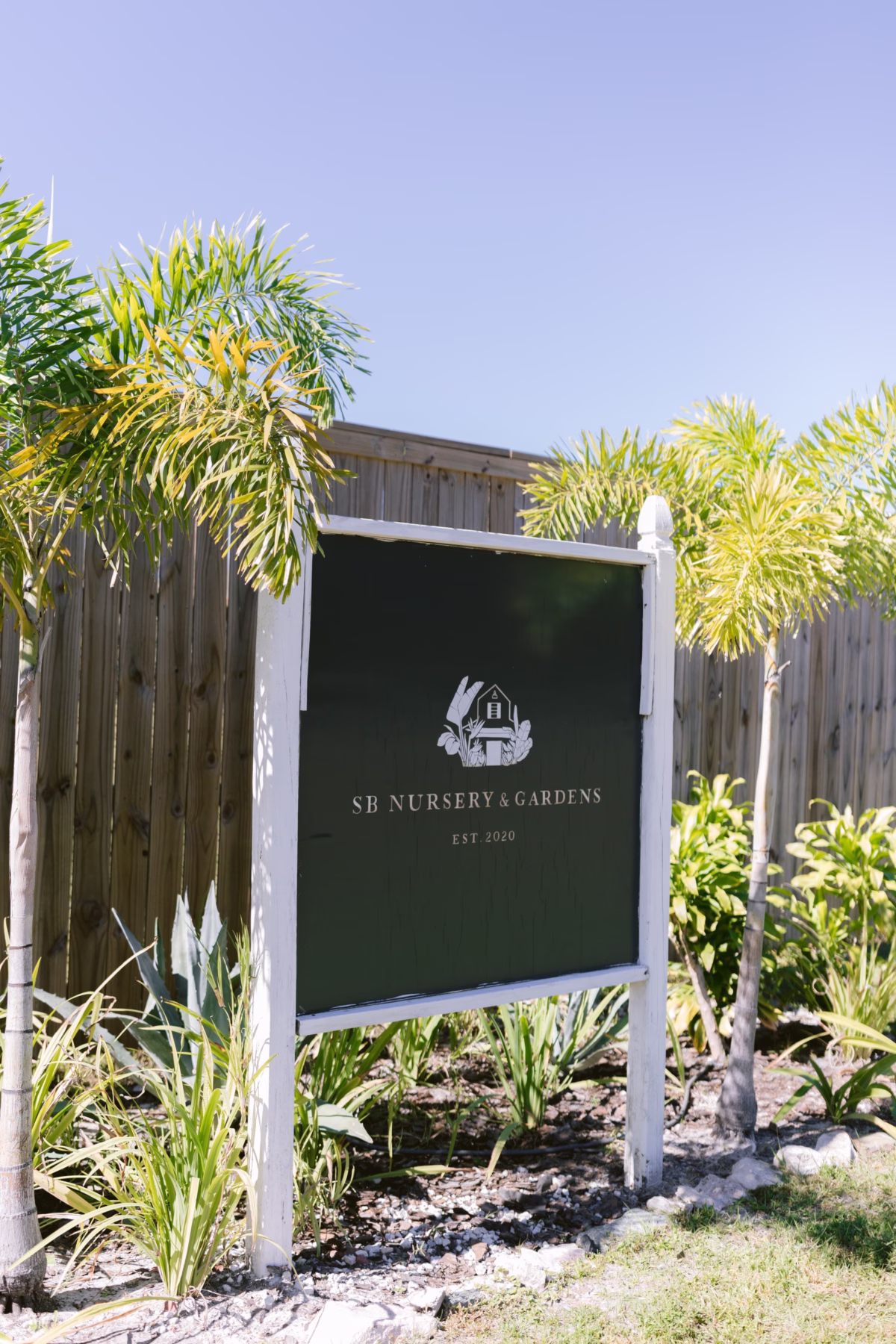 SB Nursery and Gardens wedding venue sign at Soire Estate garden wedding in Tampa surrounded by tropical landscaping