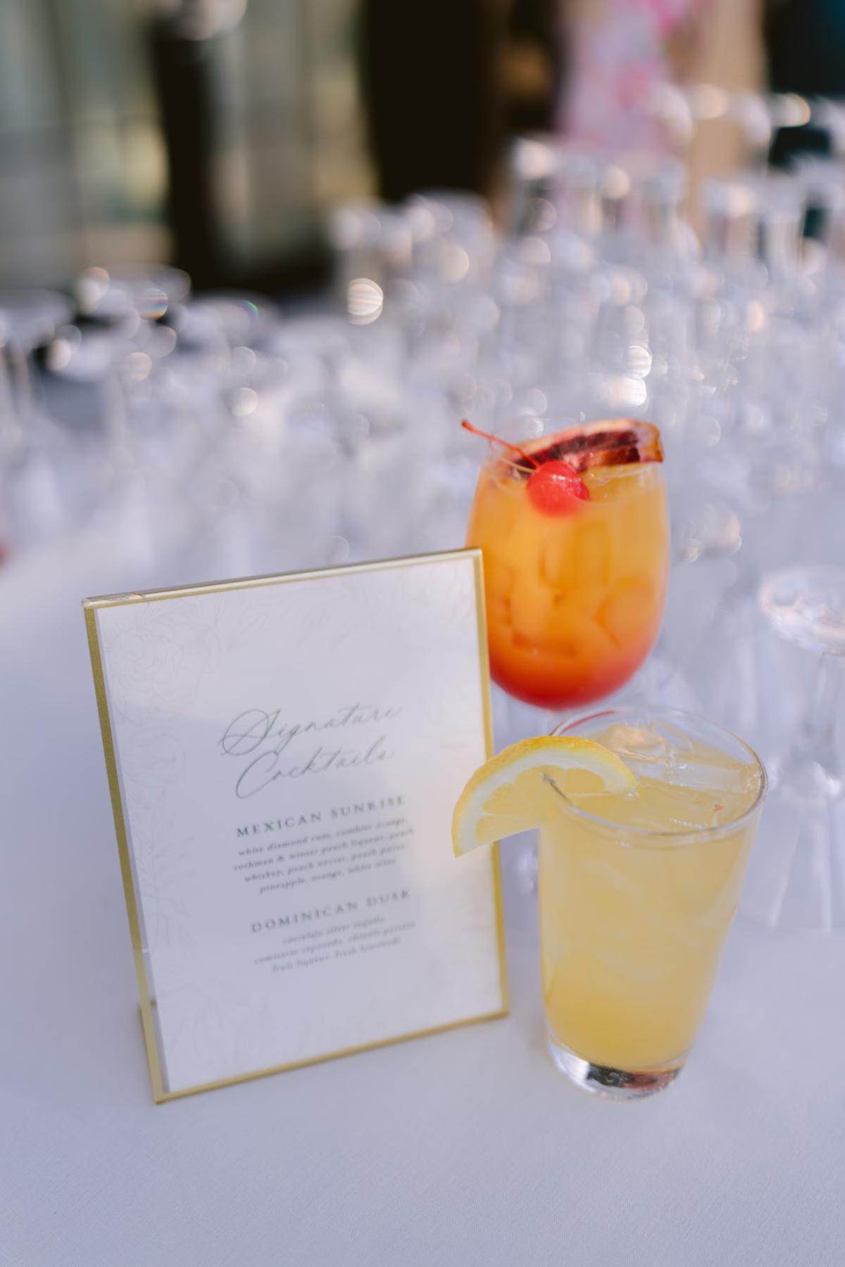 Elegant signature cocktail menu by Reverie Press displayed with colorful drinks at The Roundhouse Beacon Hudson Valley wedding
