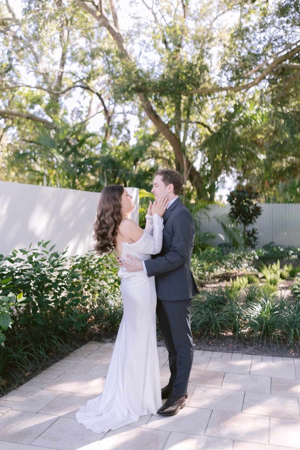 Bride and groom sharing an intimate first look moment in the lush gardens at Soire Estate Tampa wedding venue photographed by Ashley Izquierdo Photography