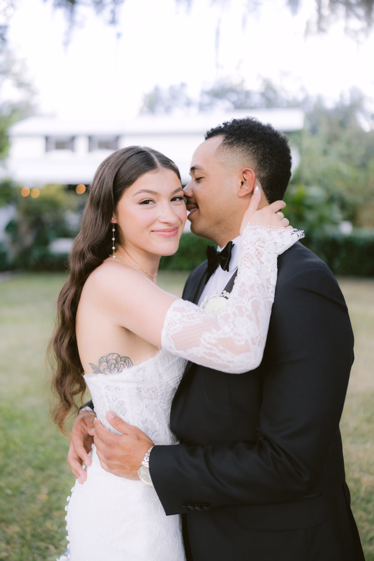 Romantic wedding couple portrait at Soire Estate Tampa featuring bride in Ella Blu Bridal gown and groom in black tuxedo