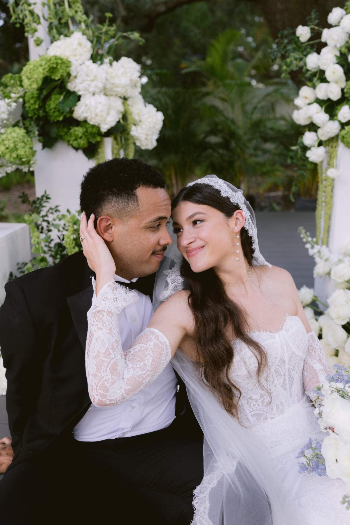 Bride and groom intimate portrait surrounded by white hydrangea florals by Ava Elise Decor at Soire Estate Tampa wedding