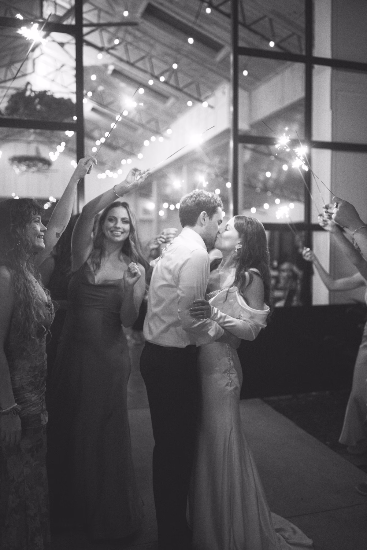 Bride and groom share romantic kiss during sparkler send off at Soire Estate Tampa wedding photographed by Ashley Izquierdo Photography