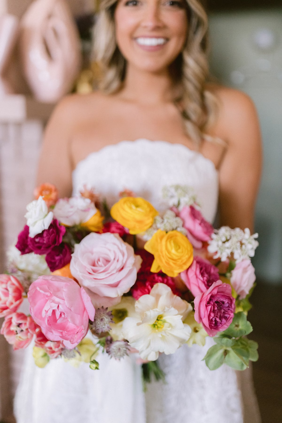 Colorful bridal bouquet with pink and yellow flowers by Petite Fleur at St Pete Shuffleboard Club wedding photographed by Ashley Izquierdo Photography