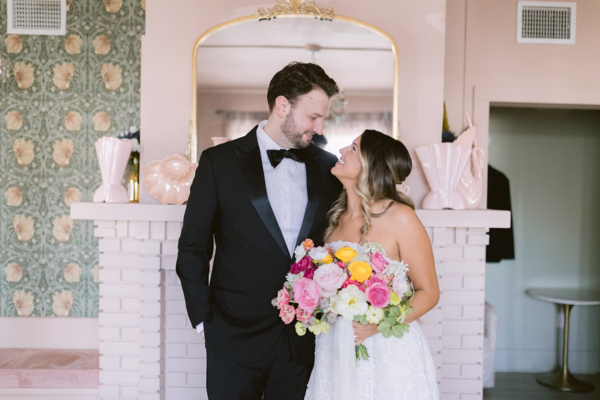Bride and groom sharing intimate moment with colorful Petite Fleur bouquet at St. Pete Shuffleboard Club wedding photographed by Ashley Izquierdo Photography