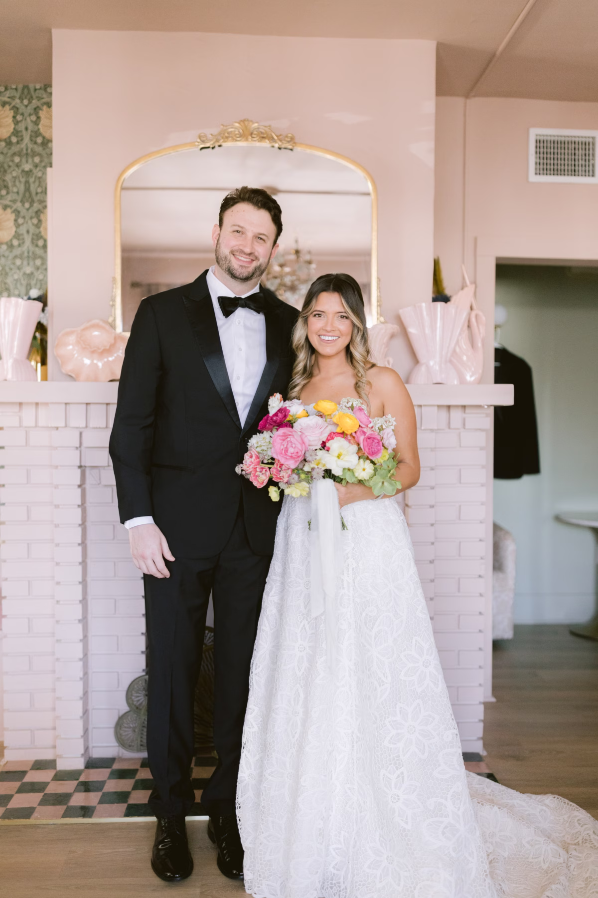 Bride and groom wedding portrait with colorful bouquet by Petite Fleur at St Pete Shuffleboard Club captured by Tampa Bay wedding photographer Ashley Izquierdo Photography