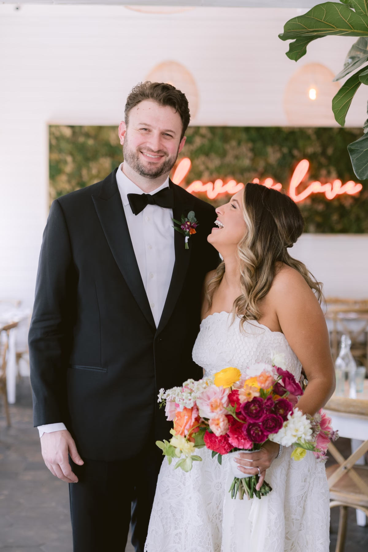 Bride and groom portrait with colorful bouquet by Petite Fleur at St. Pete Shuffleboard Club wedding photographed by Ashley Izquierdo Photography