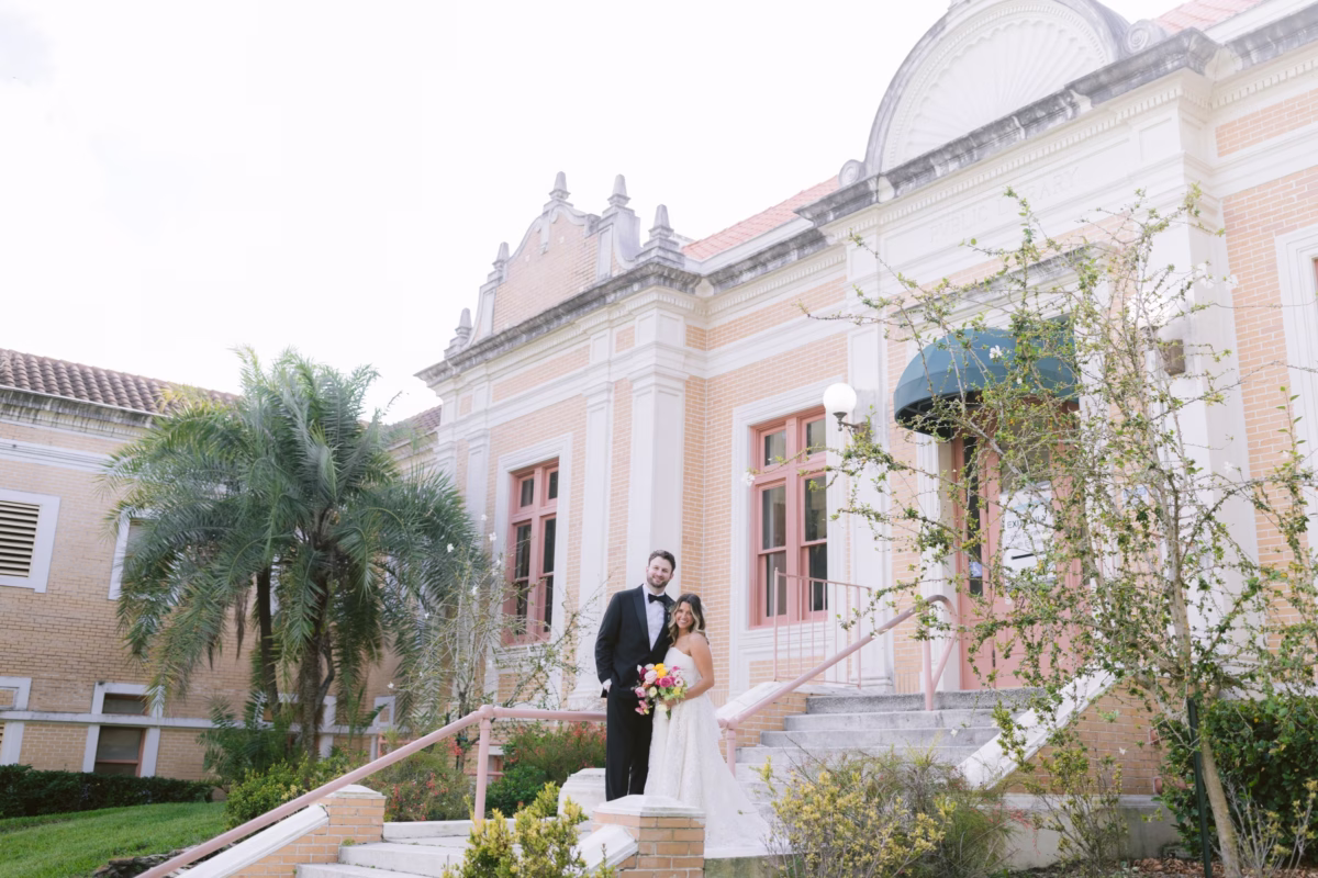 Bride and groom wedding portrait at St. Pete Shuffleboard Club with bridal bouquet by Petite Fleur and wedding planning by Day of Details