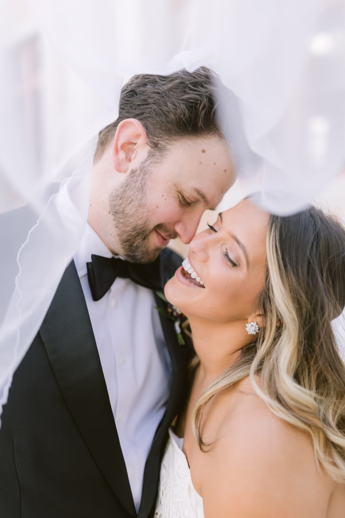 Bride and groom intimate portrait under veil at St Pete Shuffleboard Club wedding coordinated by Day of Details