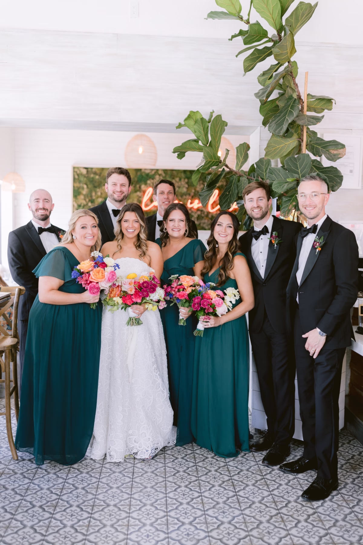 Wedding party with vibrant bouquets by Petite Fleur at St. Pete Shuffleboard Club captured by Ashley Izquierdo Photography
